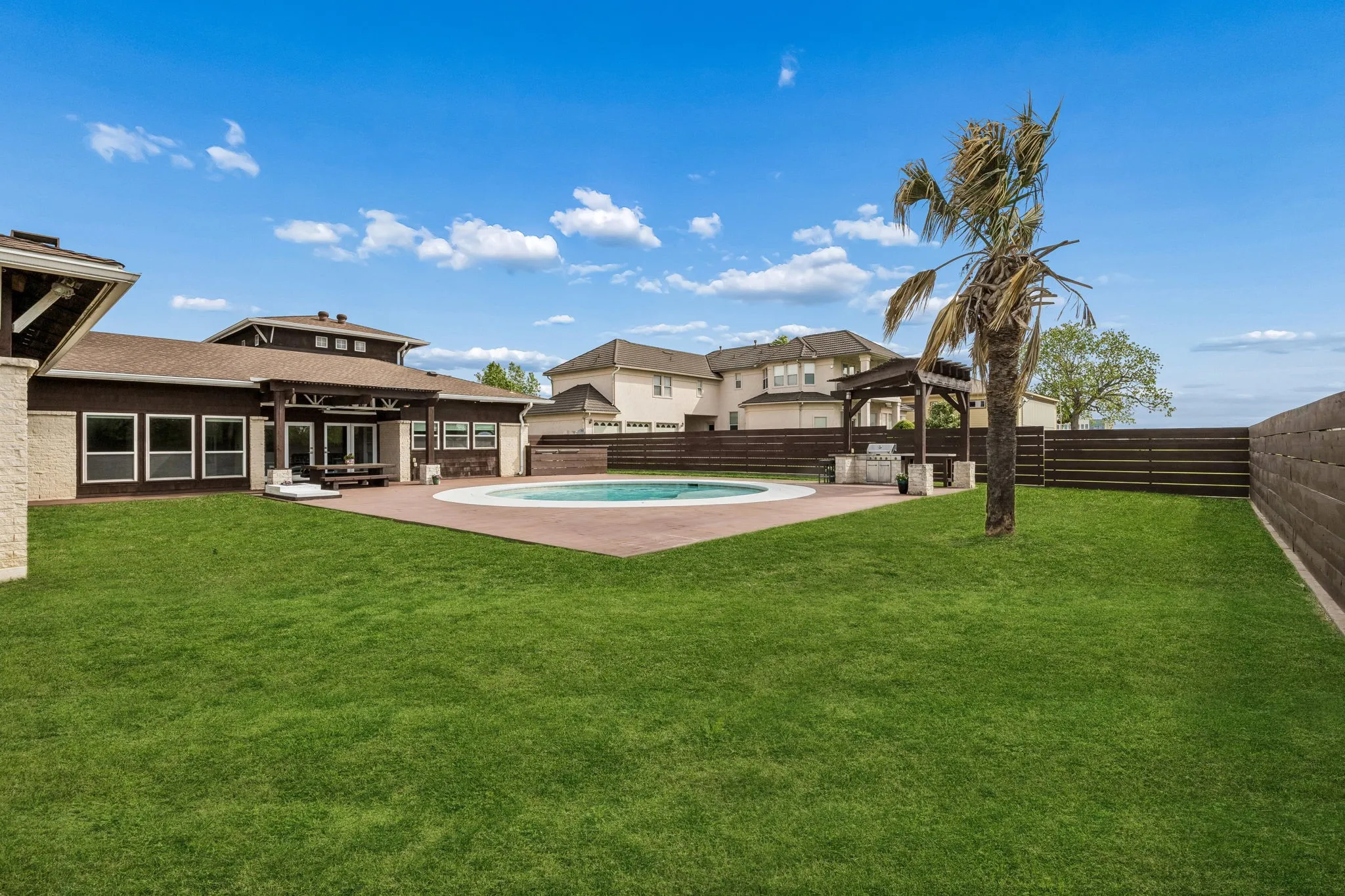 Large extra yard space.  Horizontal wood slatted back fence with two gate entrances.