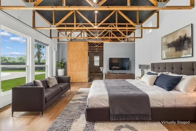Huge master suite in the back part of the home with wall of windows overlooking the pool.