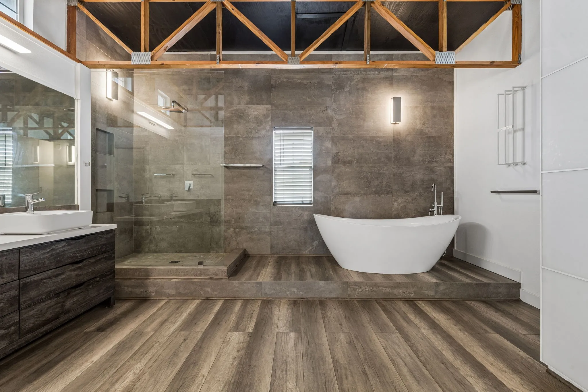 Walk in shower and separate soaking tub.  Wood beam ceiling detail.