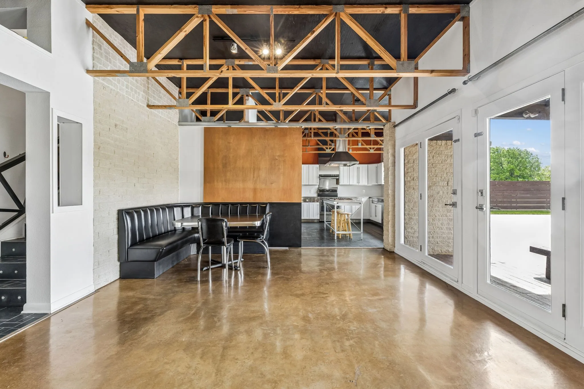 Cafe style corner custom built in breakfast nook table.  Large barn door then kitchen.