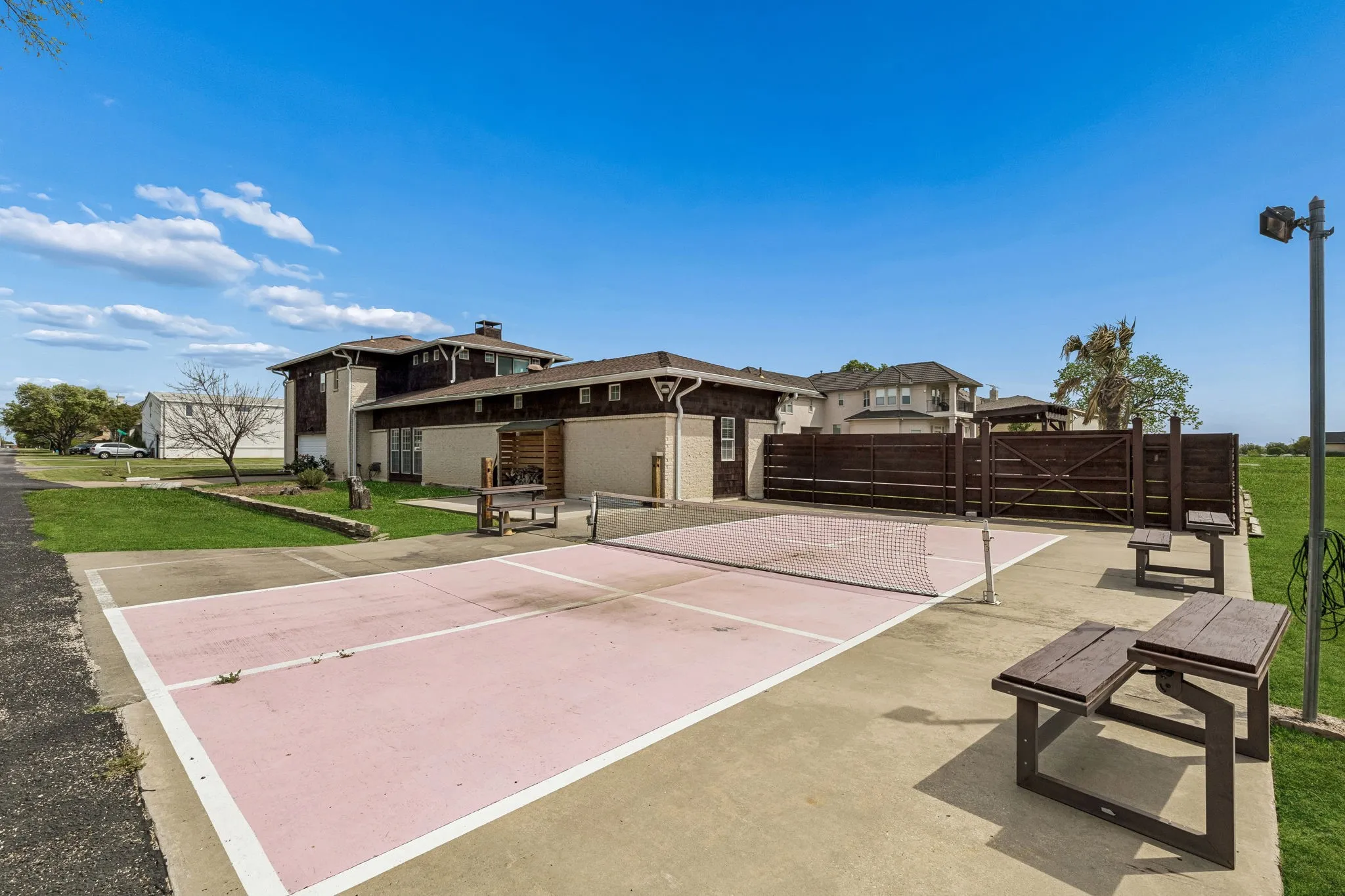 Pickle ball court on the west side of the corner lot.  Three small custom built picnic stands are movable.