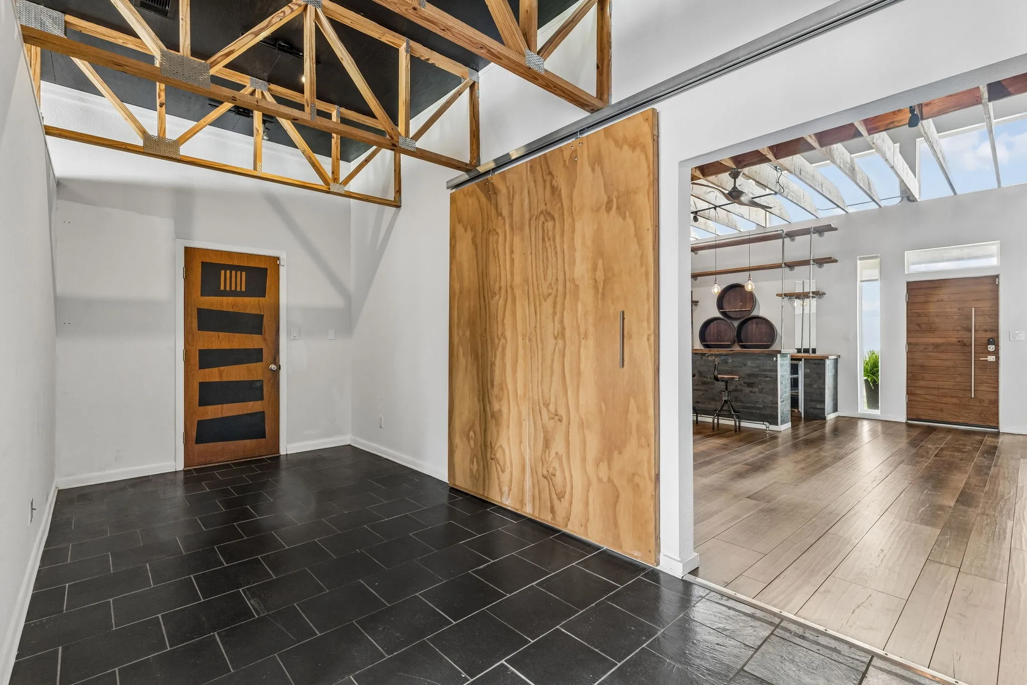 Entry to the side garage.  The garage is oversized with work shop area and storage. This hallway has room to add a MUD area or furniture piece.