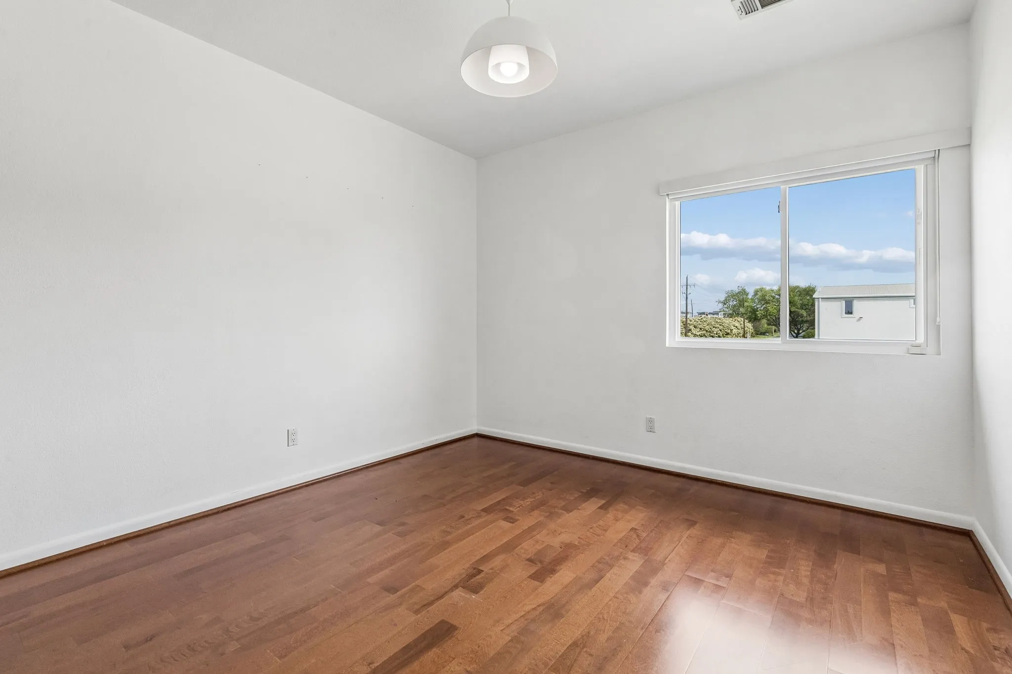 Bedroom 4 upstairs with wood flooring.
