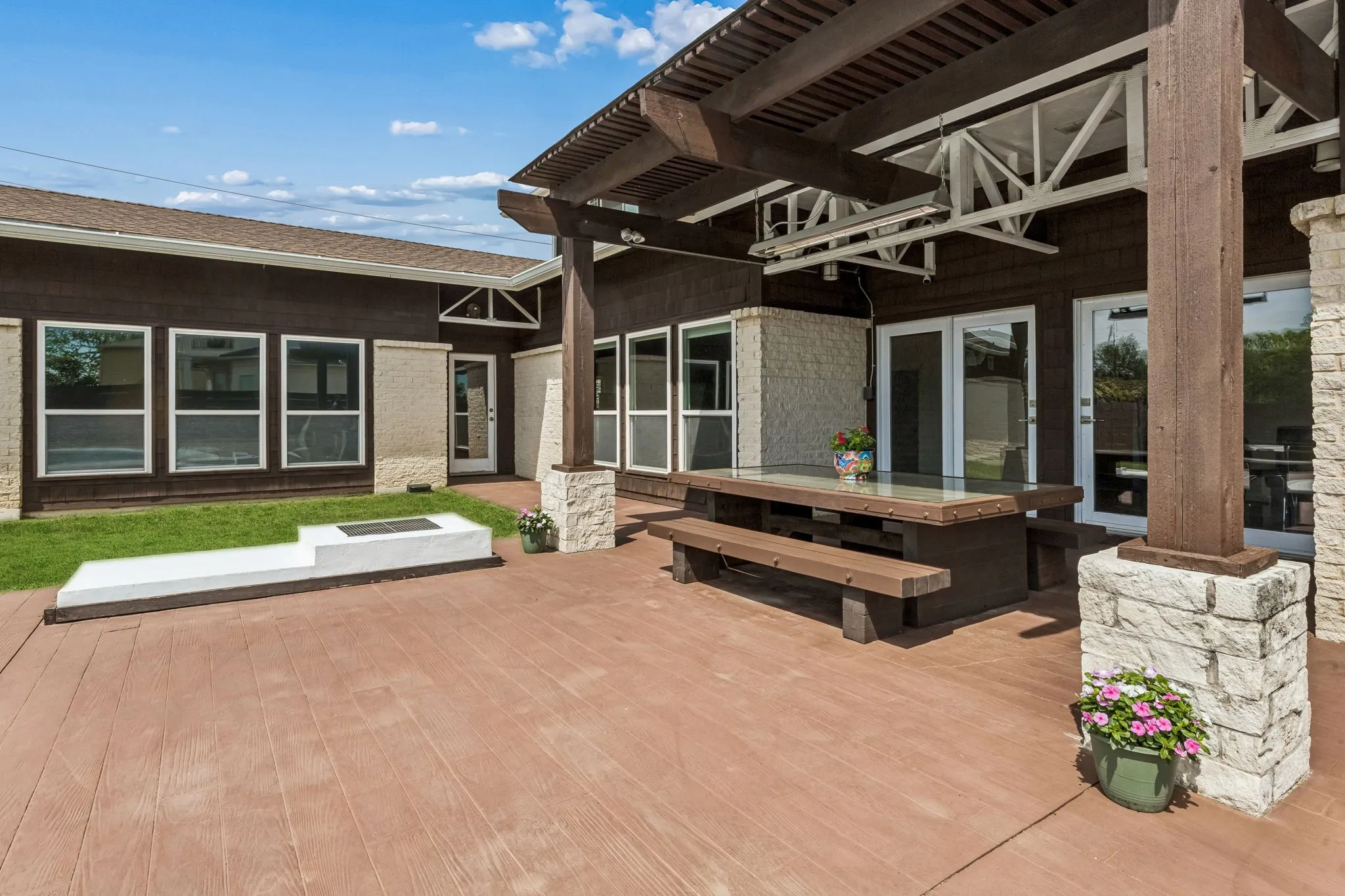 Outdoor fire pit with grill cover by the back patio.