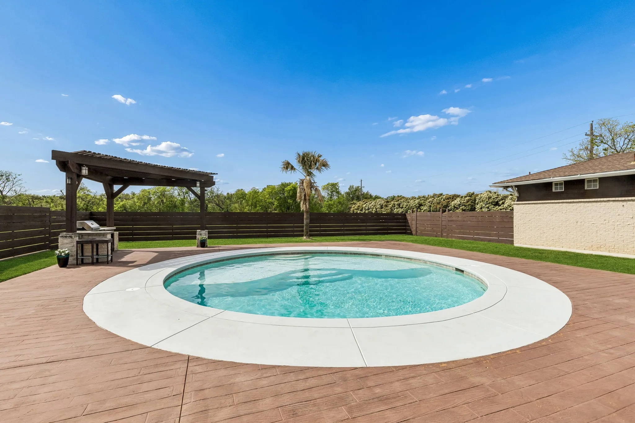 Close up view of the pool and the wood look stained concrete decking.