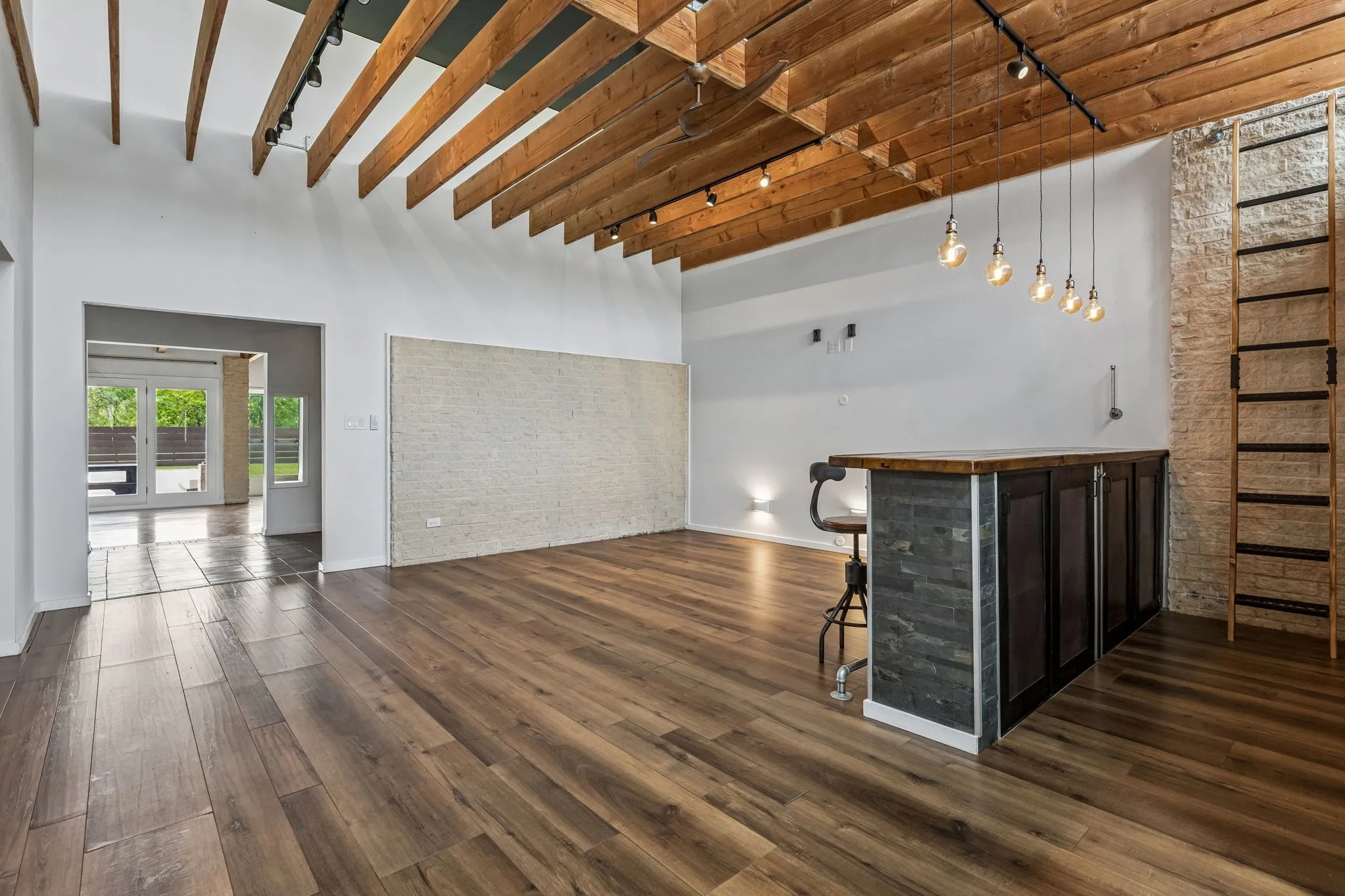 Another view of the front living room leading to the back den and patio.