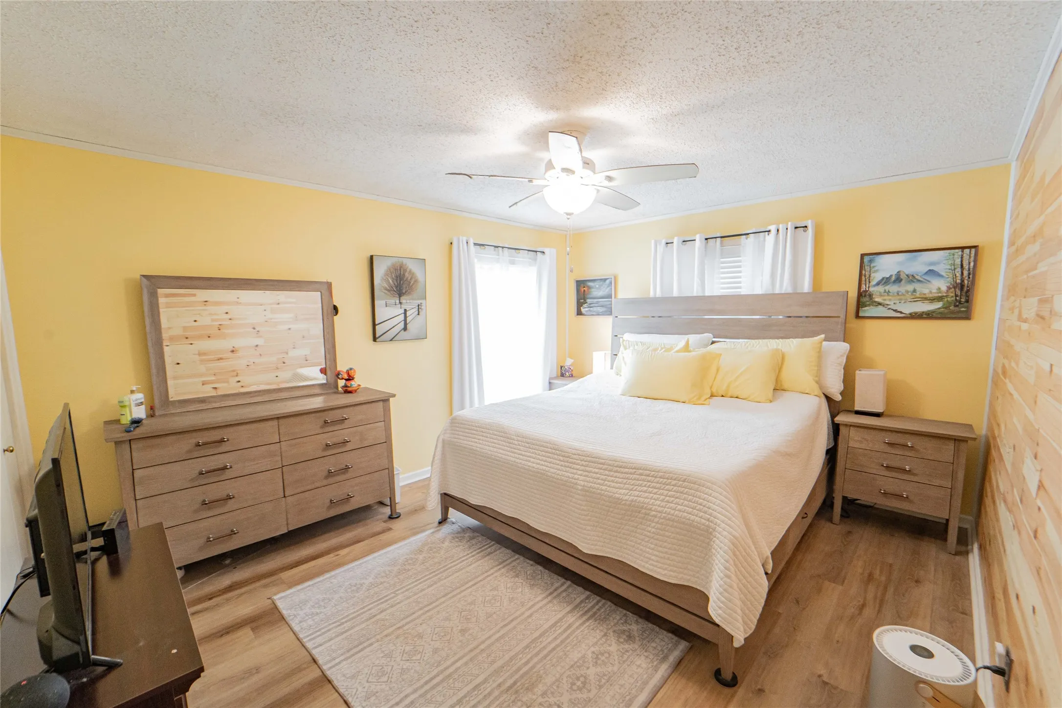 Primary Bedroom featuring wood accent wall