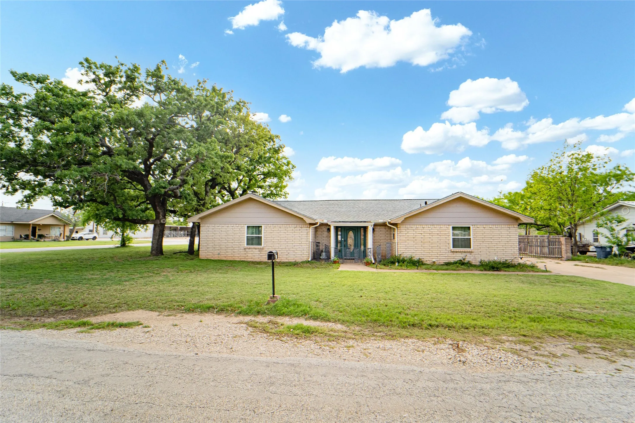 Ranch-style home with a front lawn and brick siding