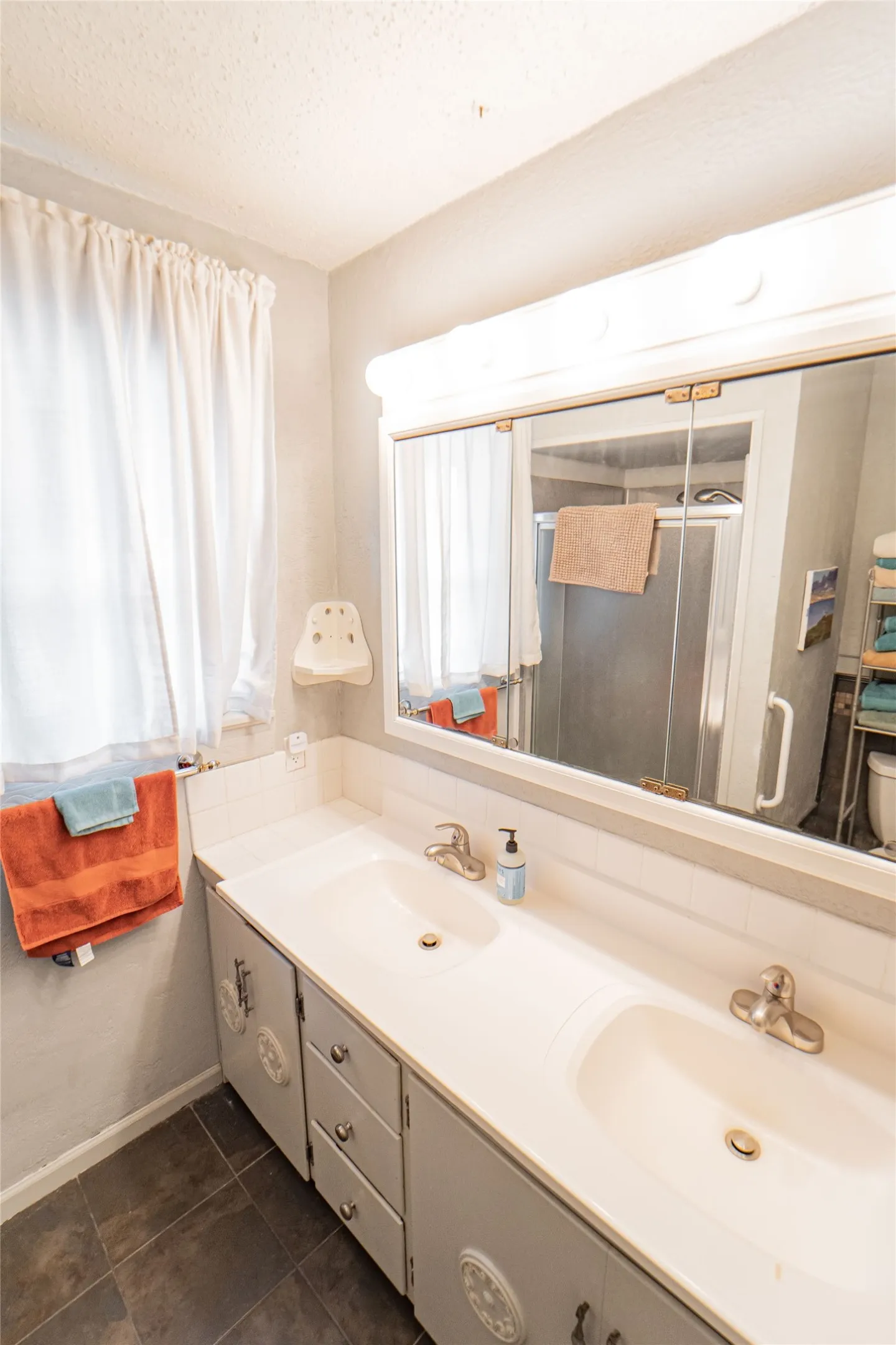 Full bath featuring double vanity