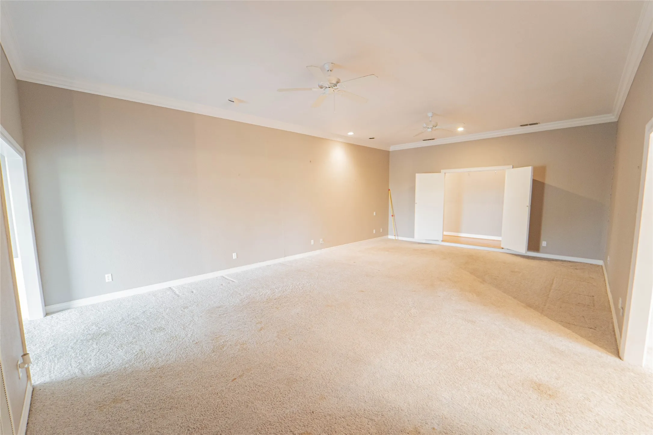 Empty room with ornamental molding, light colored carpet, ceiling fan, and recessed lighting