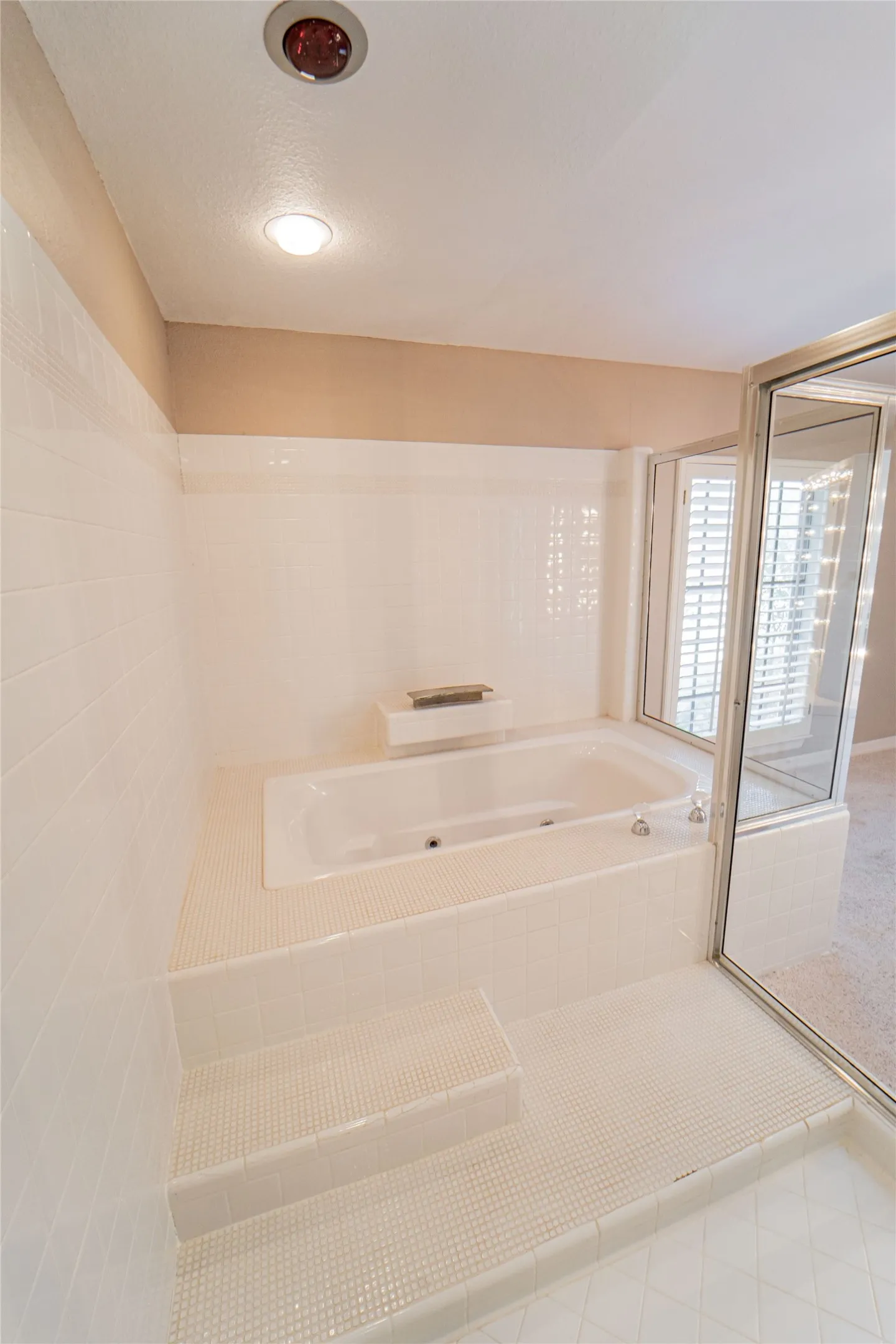 Full bath with a garden tub, a shower stall, and carpet flooring