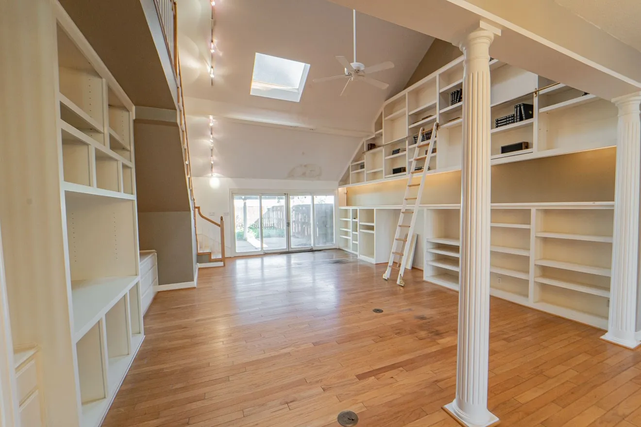 Family Room with floor to ceiling book shelves.