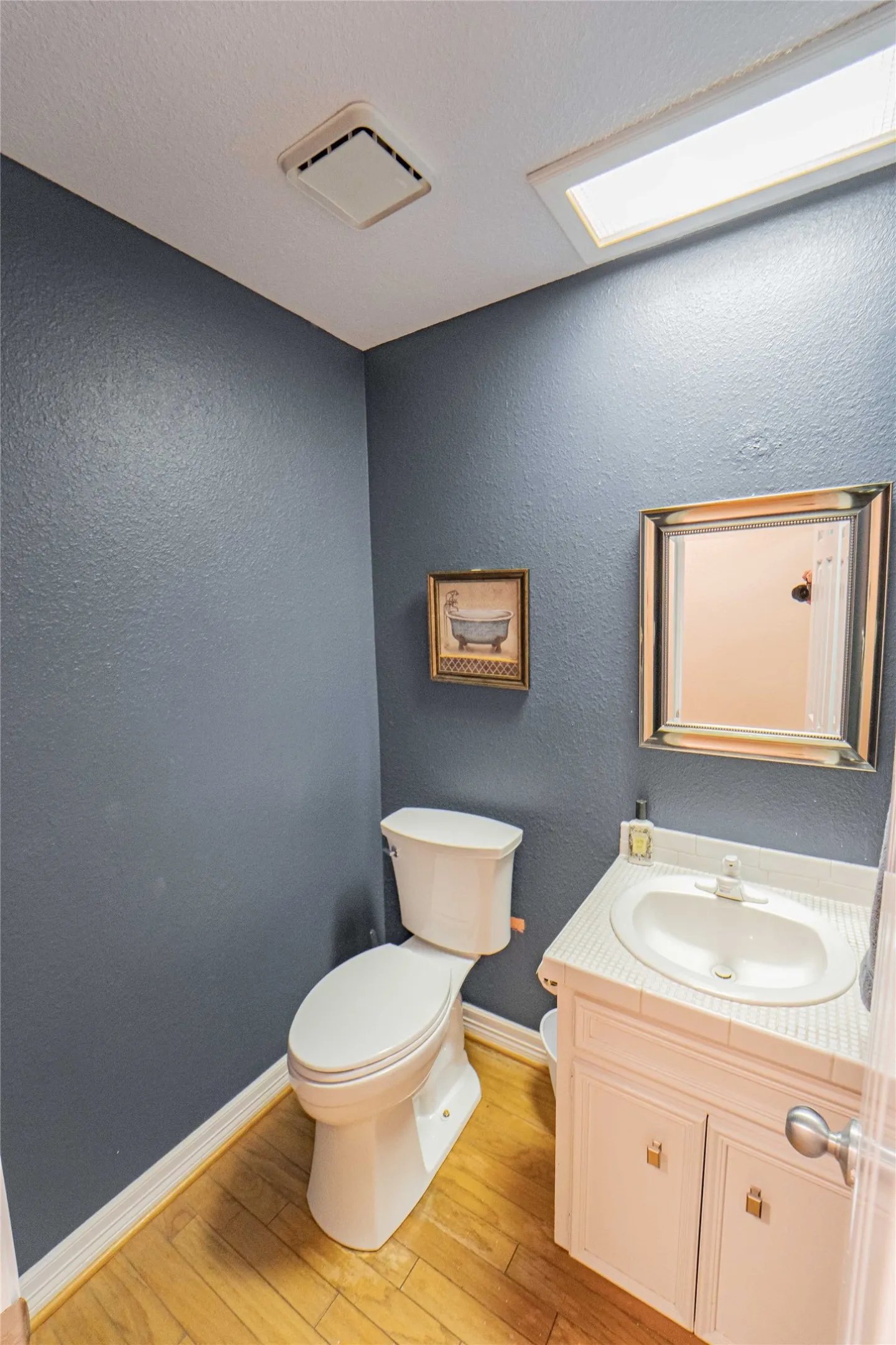 Half bath located just off of the kitchen.