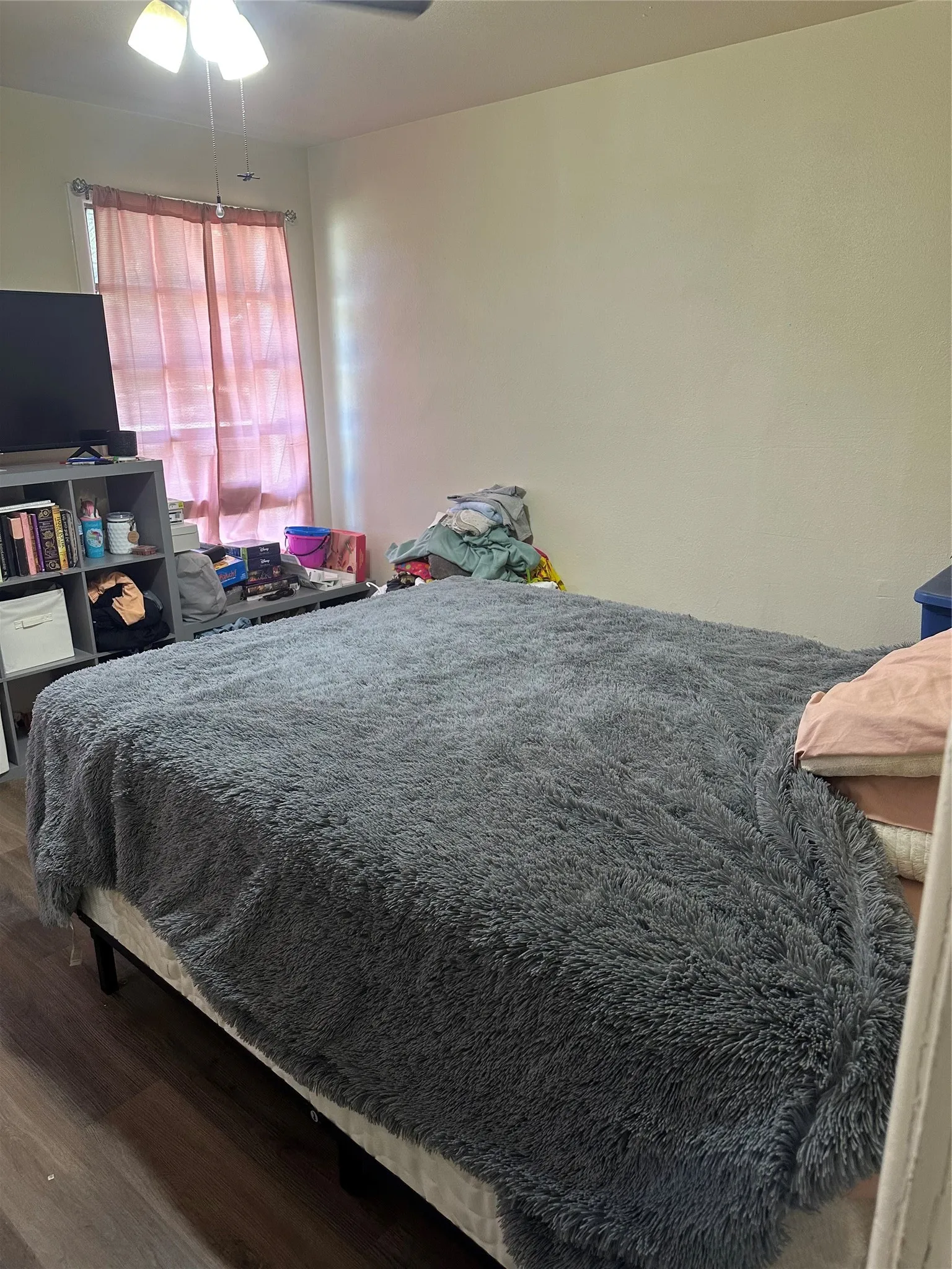 Bedroom with a ceiling fan and wood finished floors