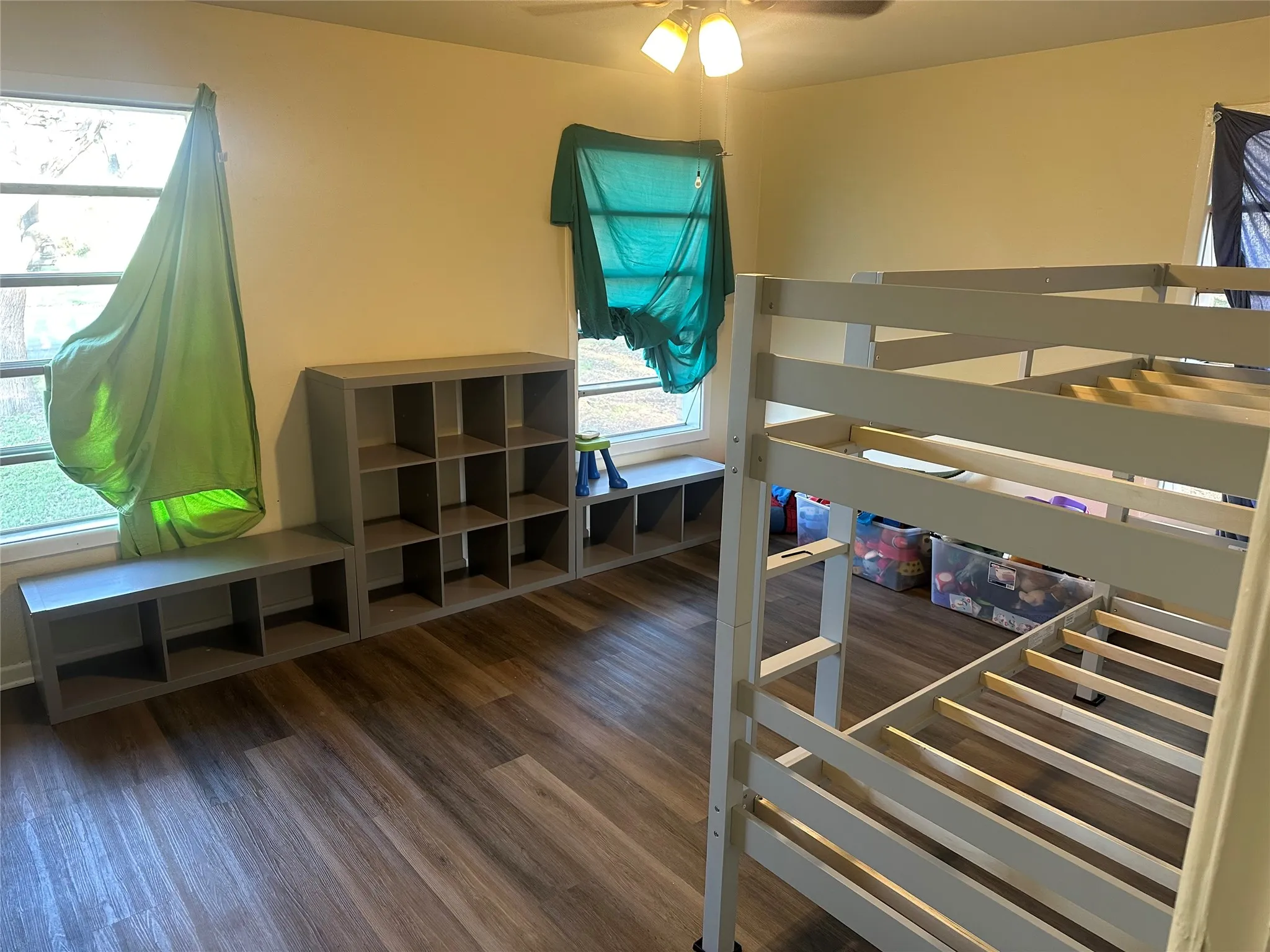 Bedroom with dark wood finished floors and ceiling fan