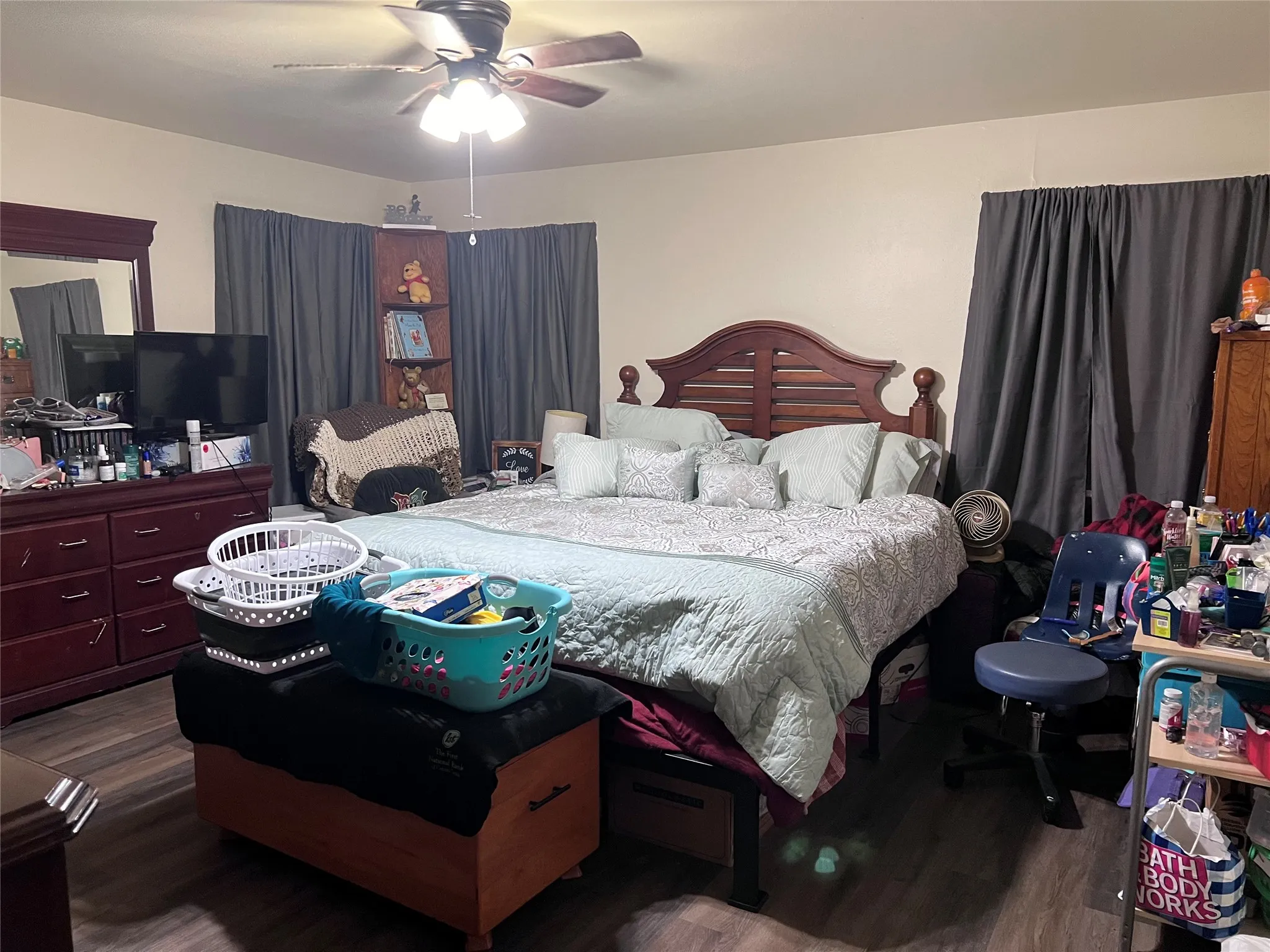 Bedroom featuring ceiling fan and dark wood finished floors