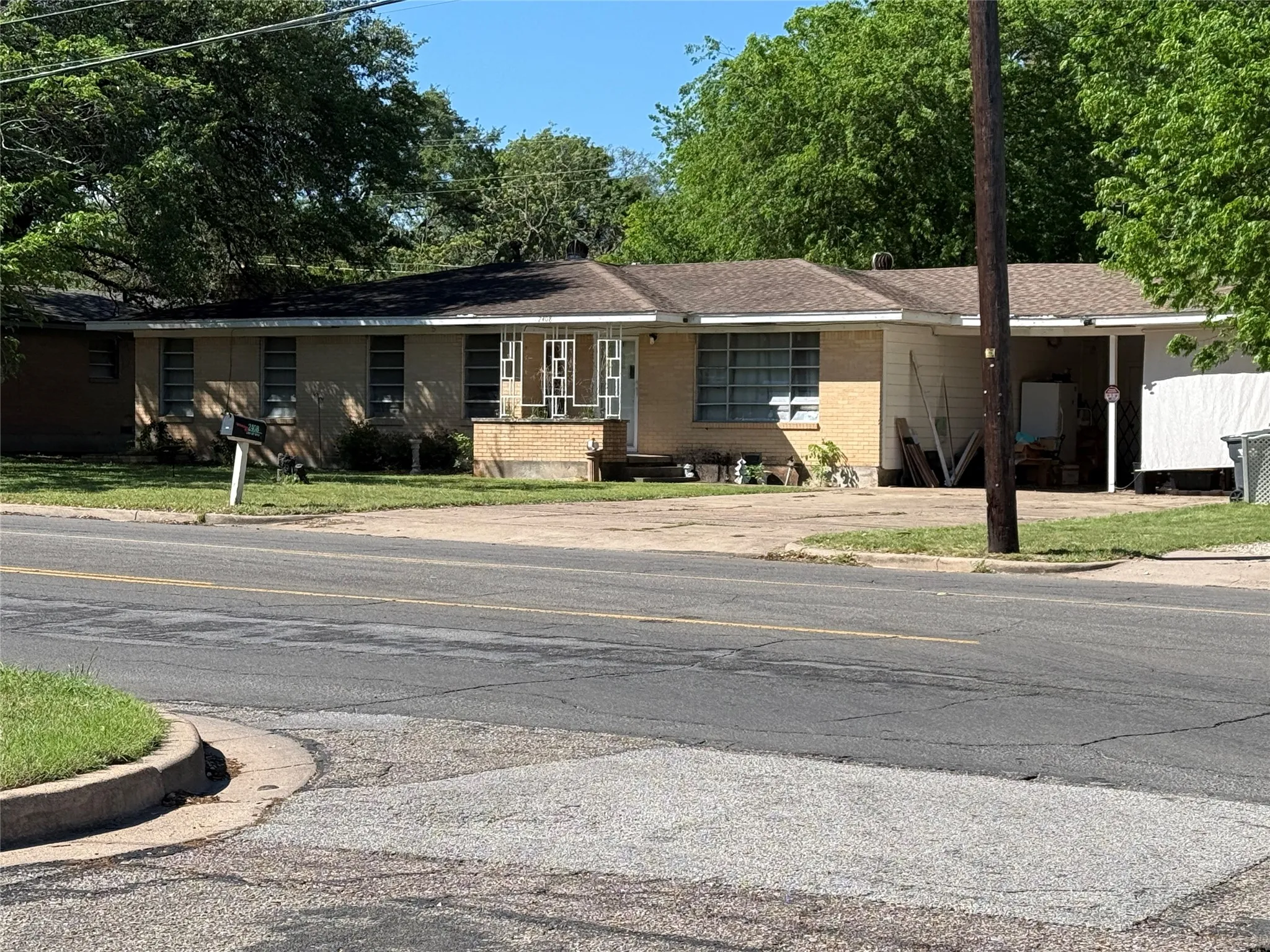 Single story home with brick siding and a front yard