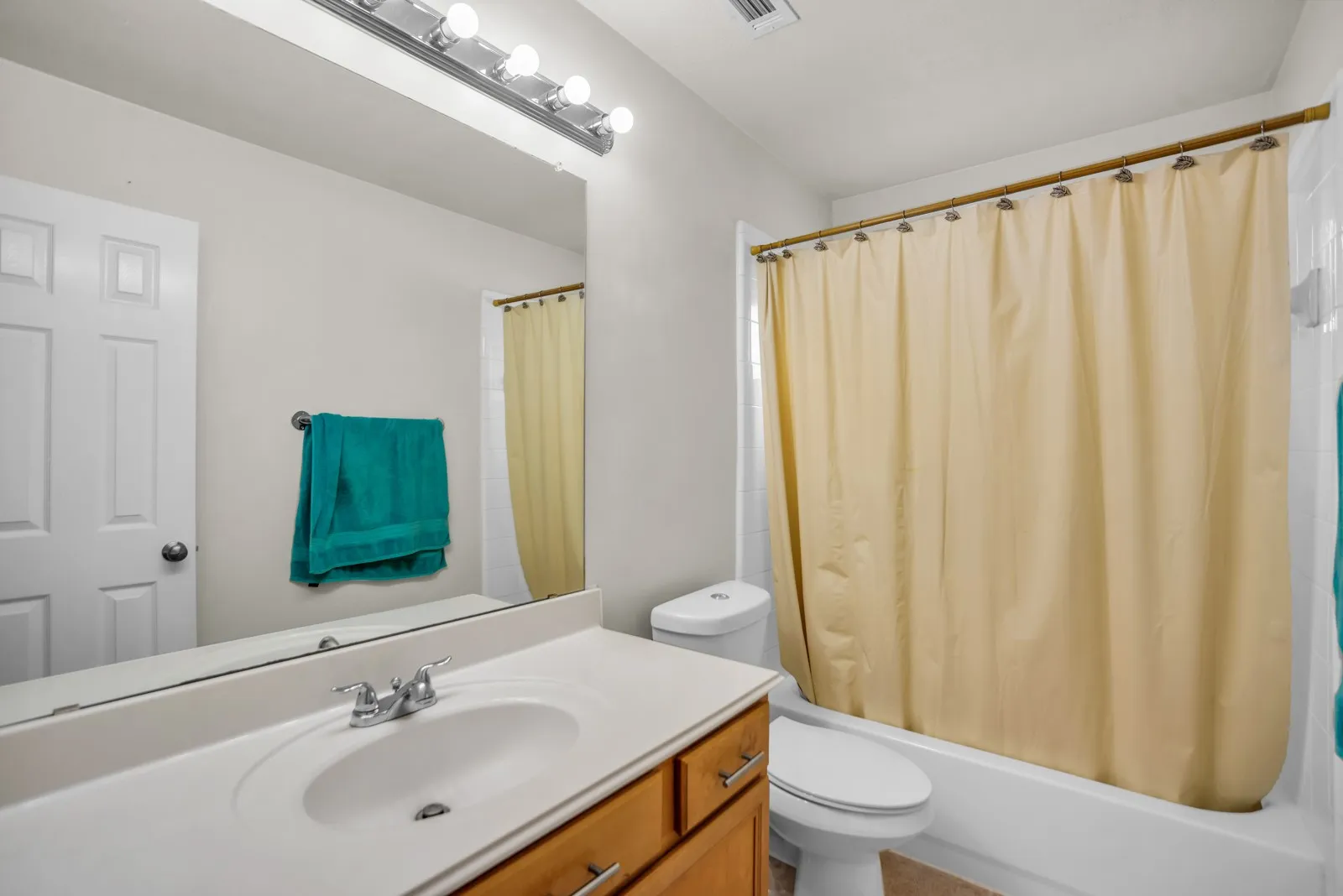 Bathroom featuring vanity and shower / bath combo with shower curtain