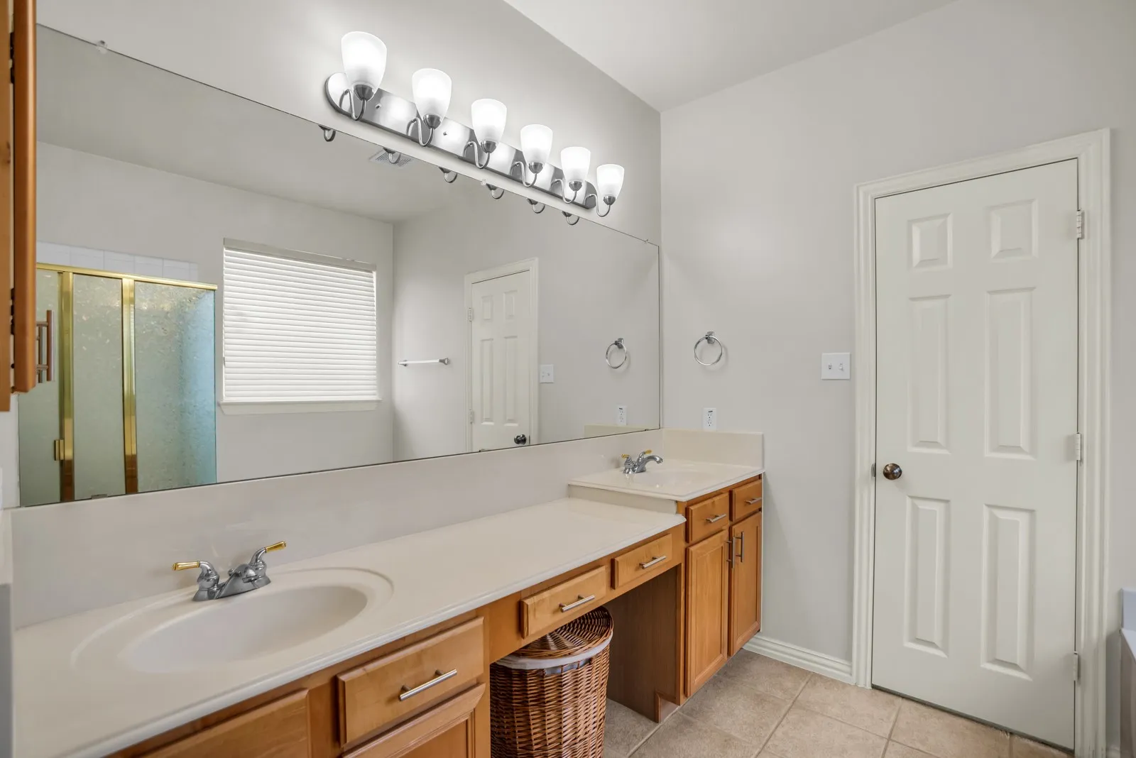 Full bathroom featuring double vanity, a stall shower, light tile patterned floors, and a bath