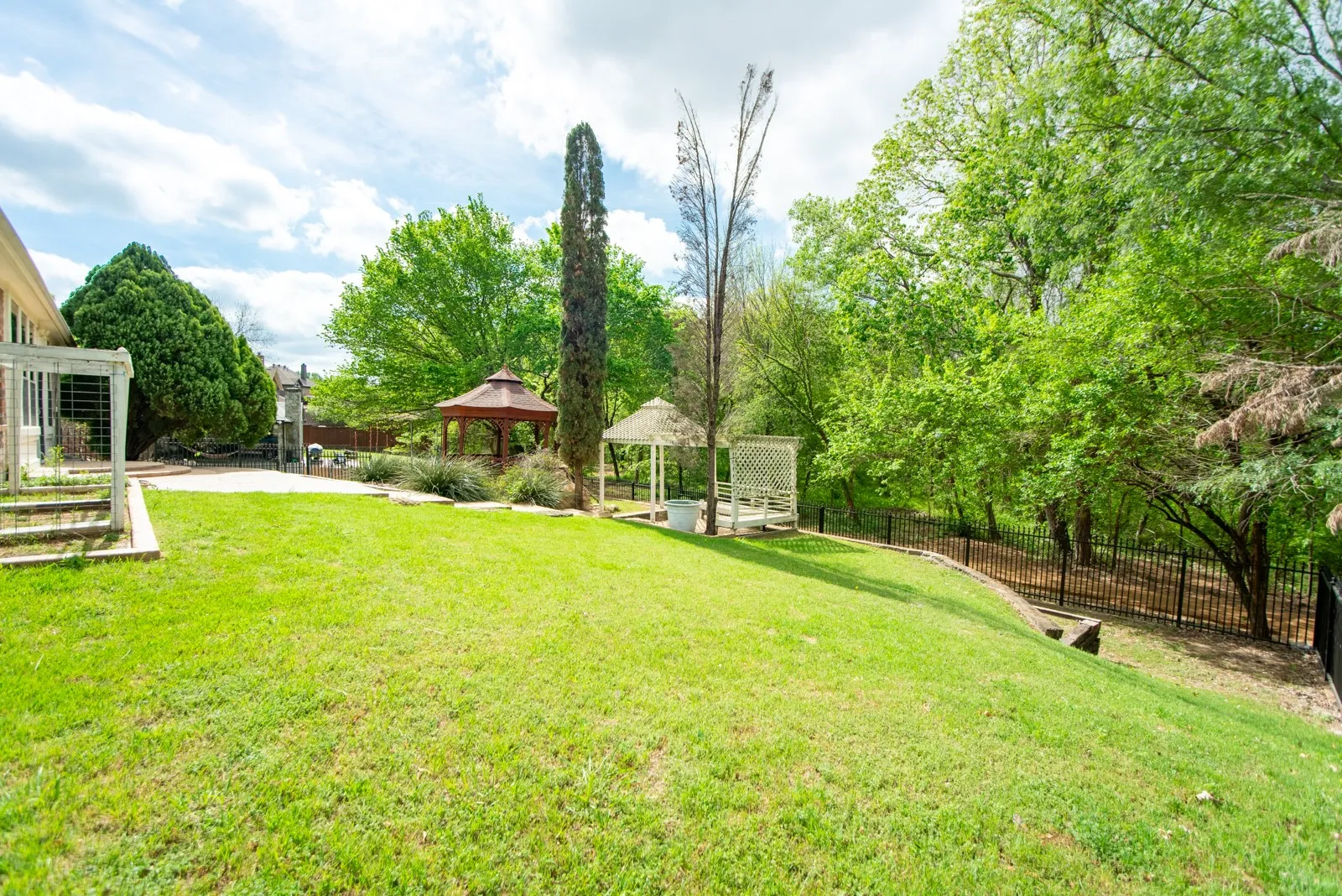 View of yard with a patio, a gazebo, and view of scattered trees