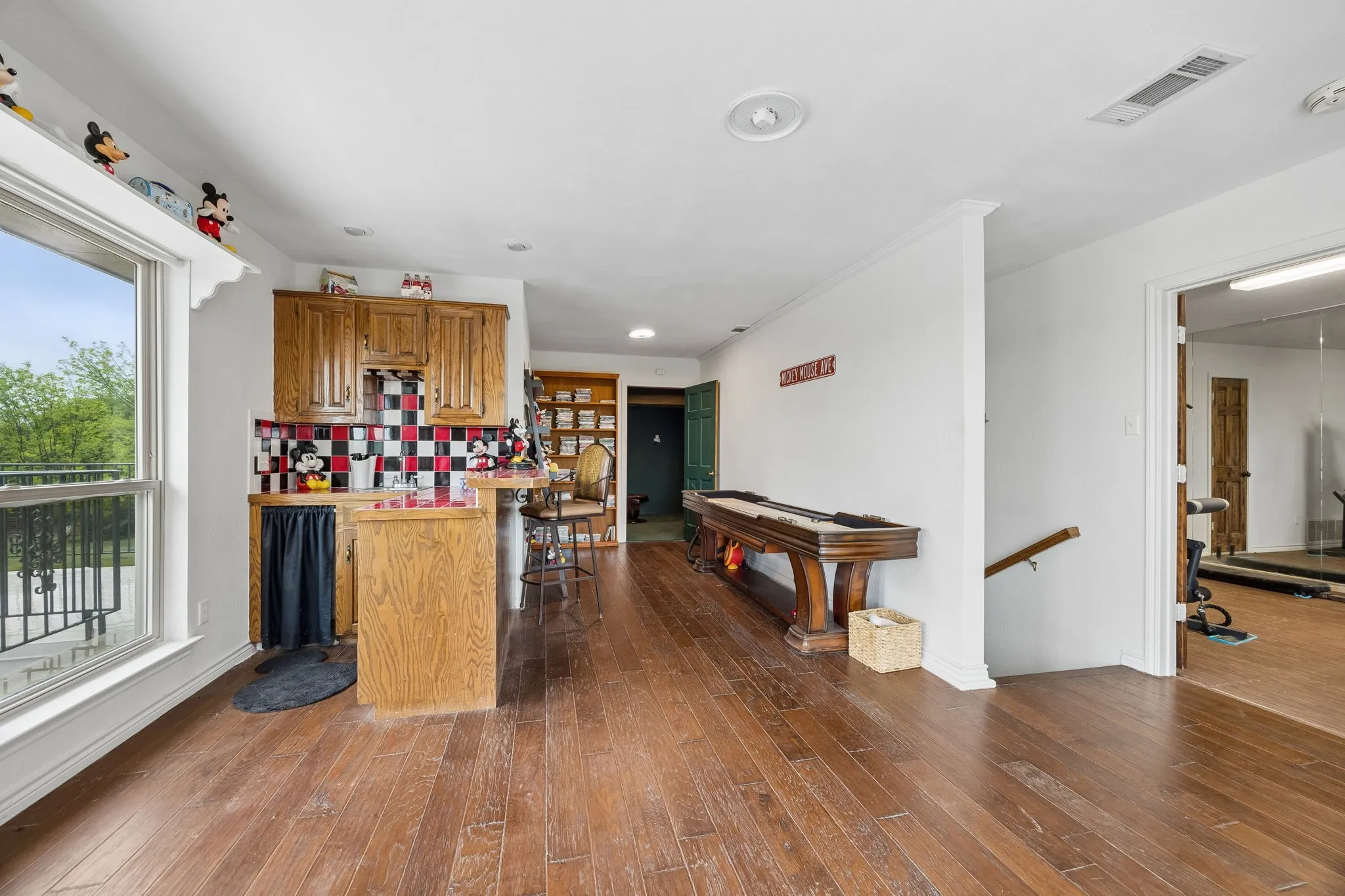 Upstairs suite, with bedroom (currently gym), cozy living room/eating area, full bath, media room (that could be a gaming room, nursery, etc) and bar that could easily convert to a kitchenette