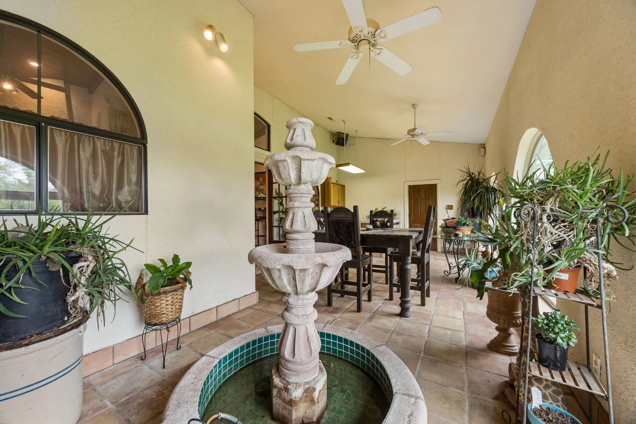 Garden room with built in fountain, surrounded in windows, very large room