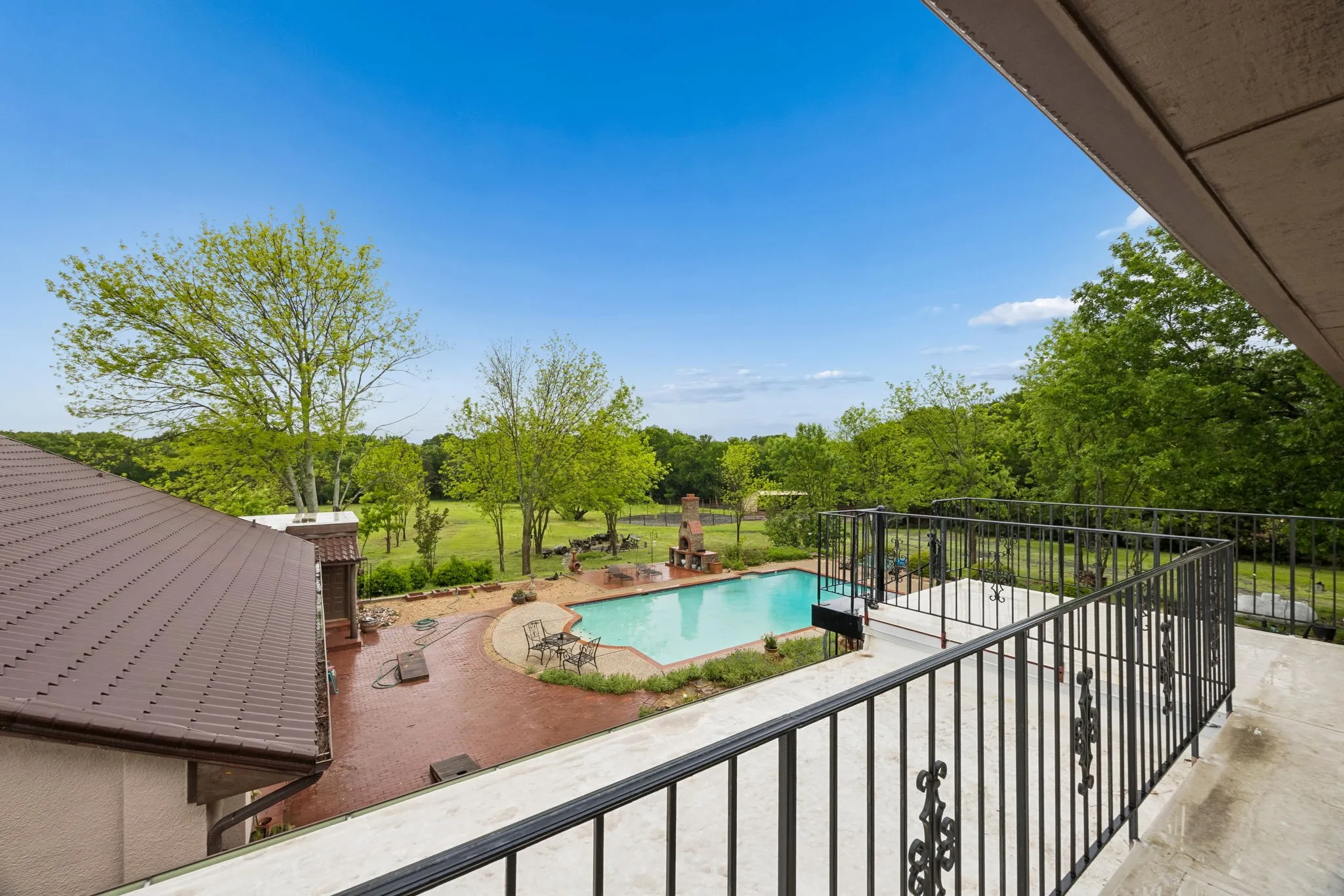 Balcony overlooking pool/entertaining courtyard and expansive gorgeous acreage!