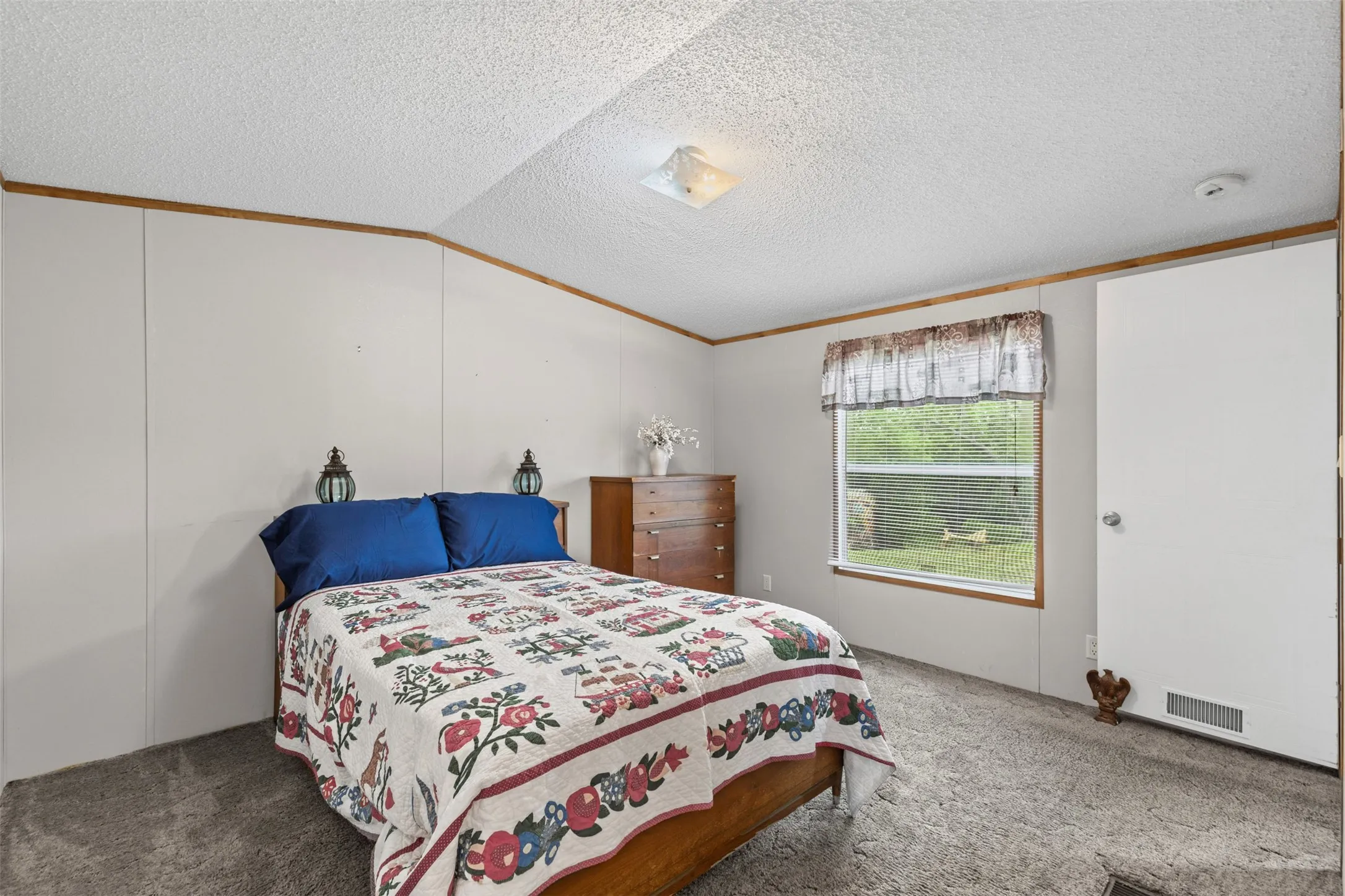 Bedroom featuring carpet floors and crown molding