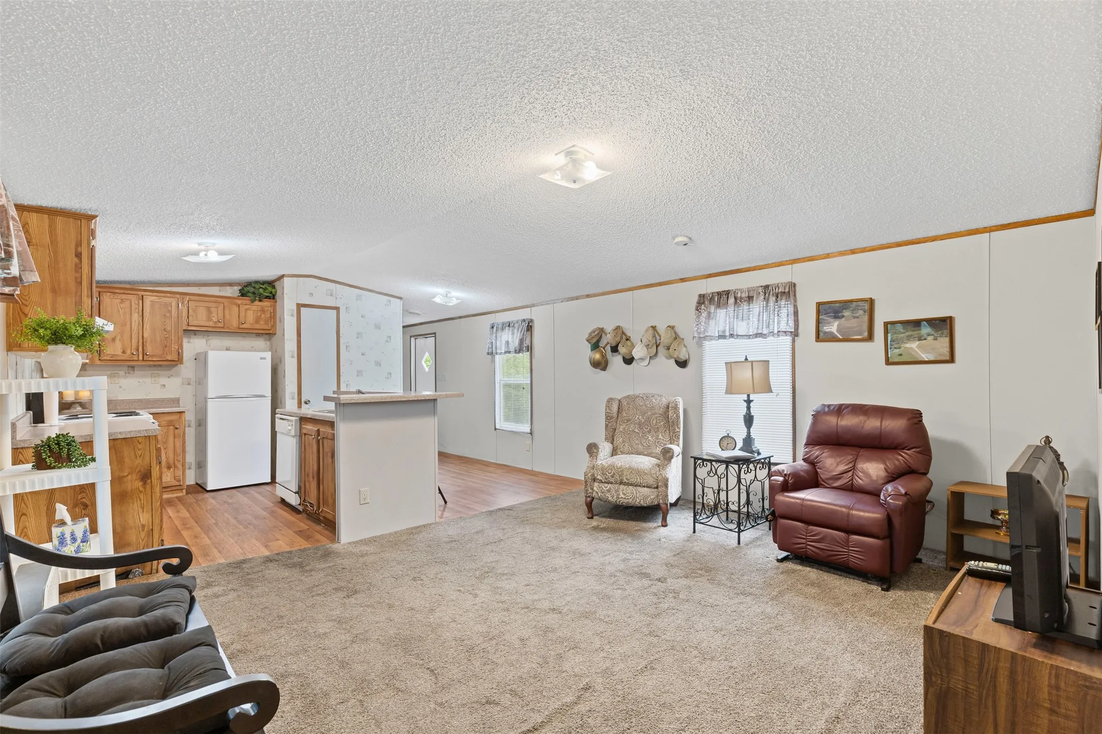 Living room featuring ornamental molding and light carpet