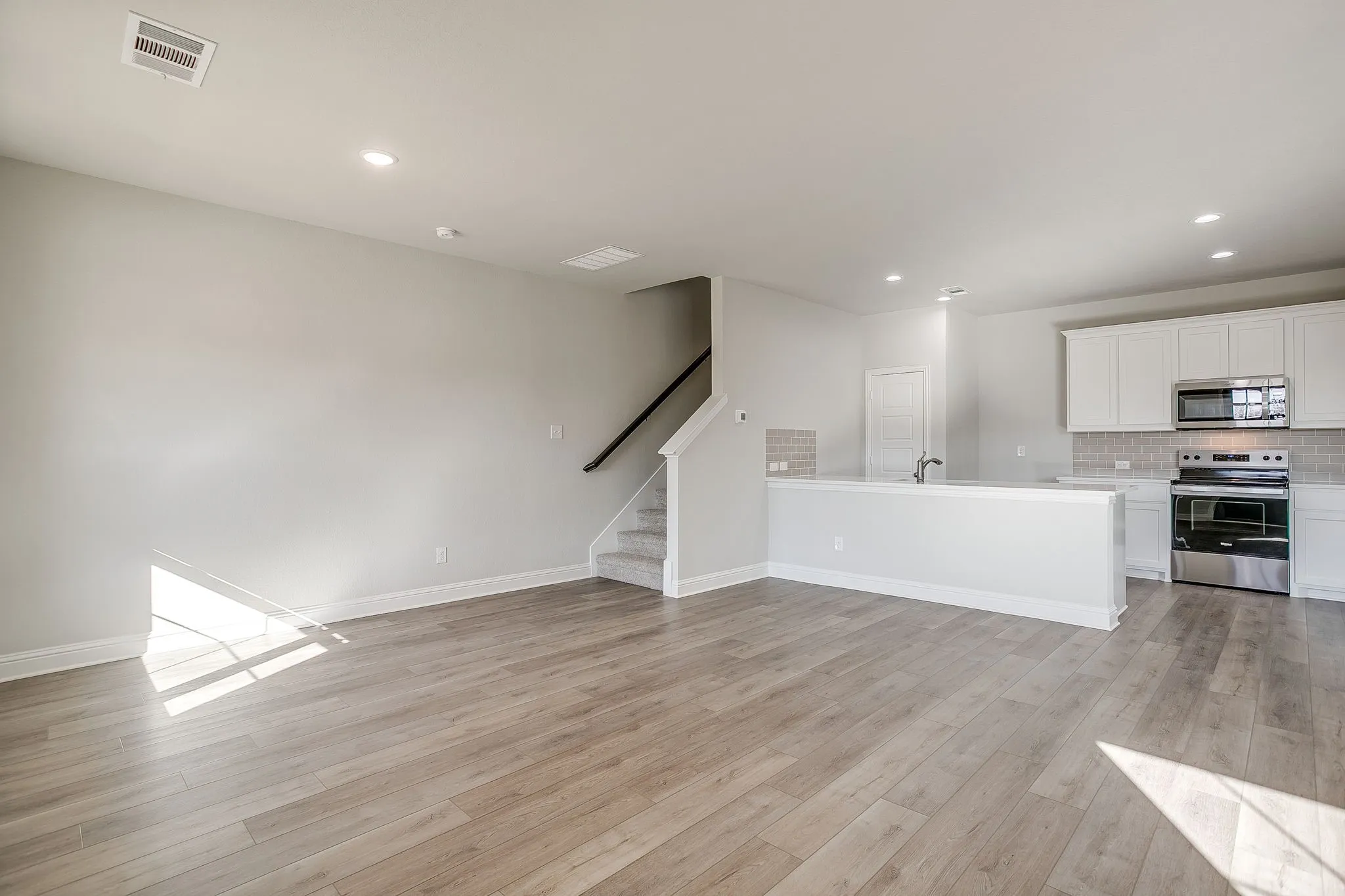 Unfurnished living room with light wood-style flooring and recessed lighting