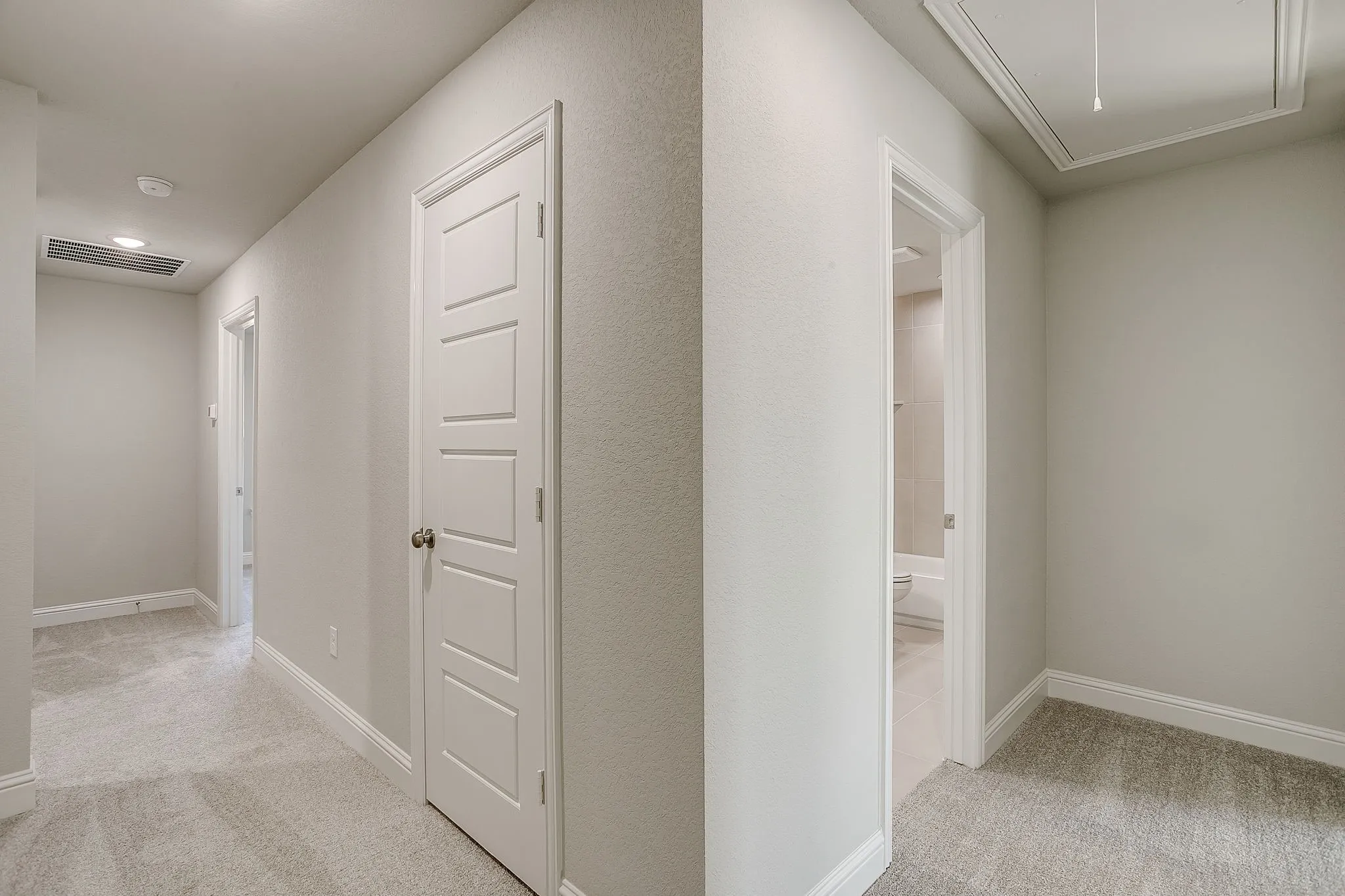 Hall with light colored carpet