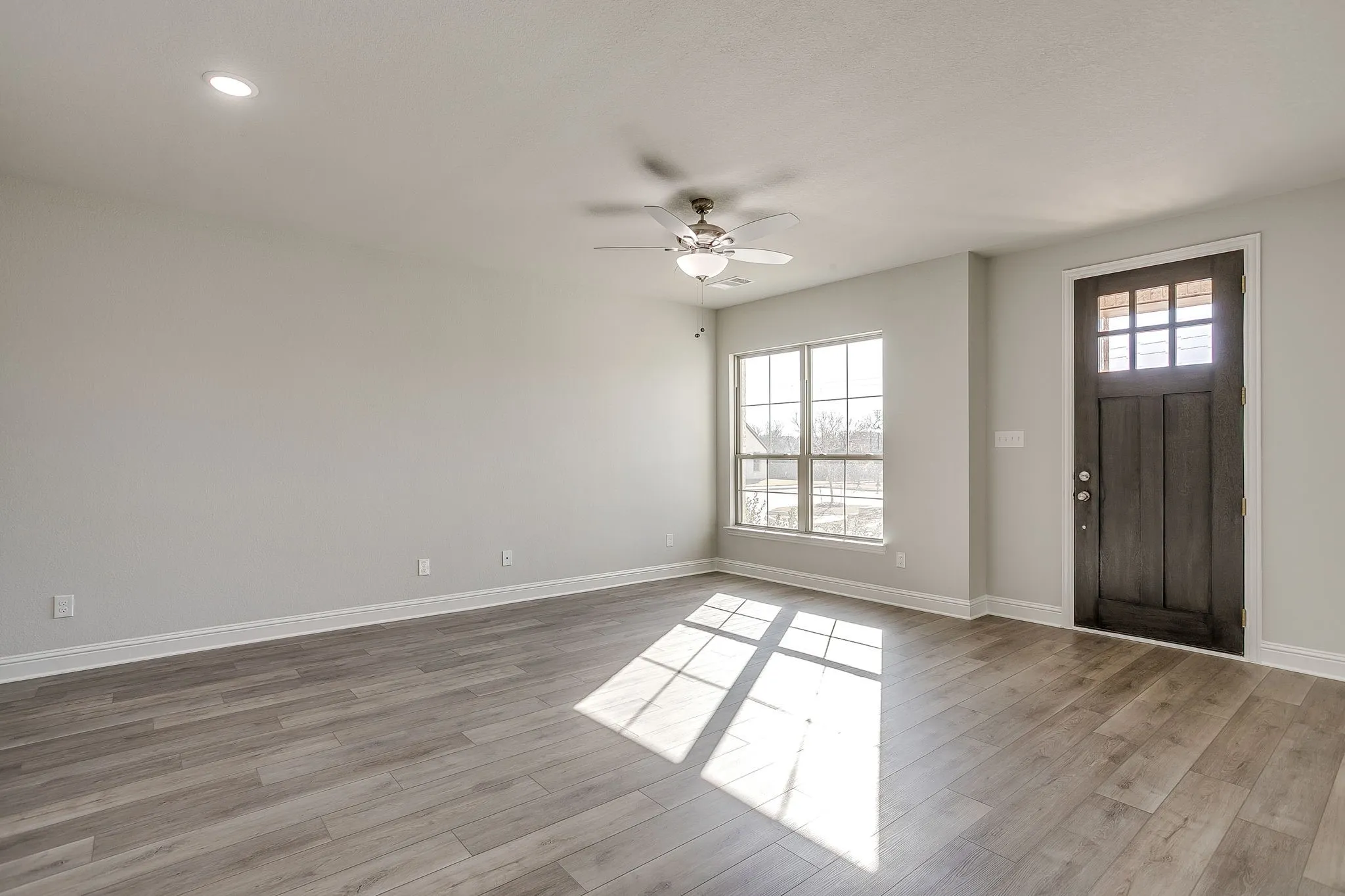 Foyer featuring ceiling fan and light wood-style flooring