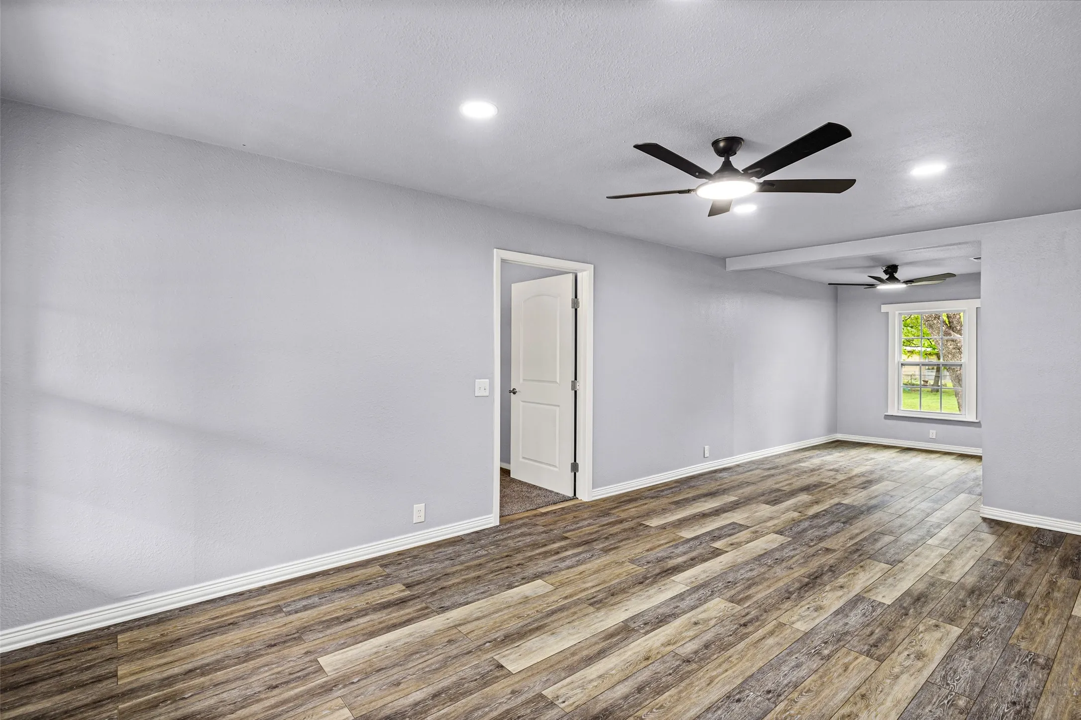 Unfurnished room featuring dark wood-style floors, recessed lighting, and ceiling fan