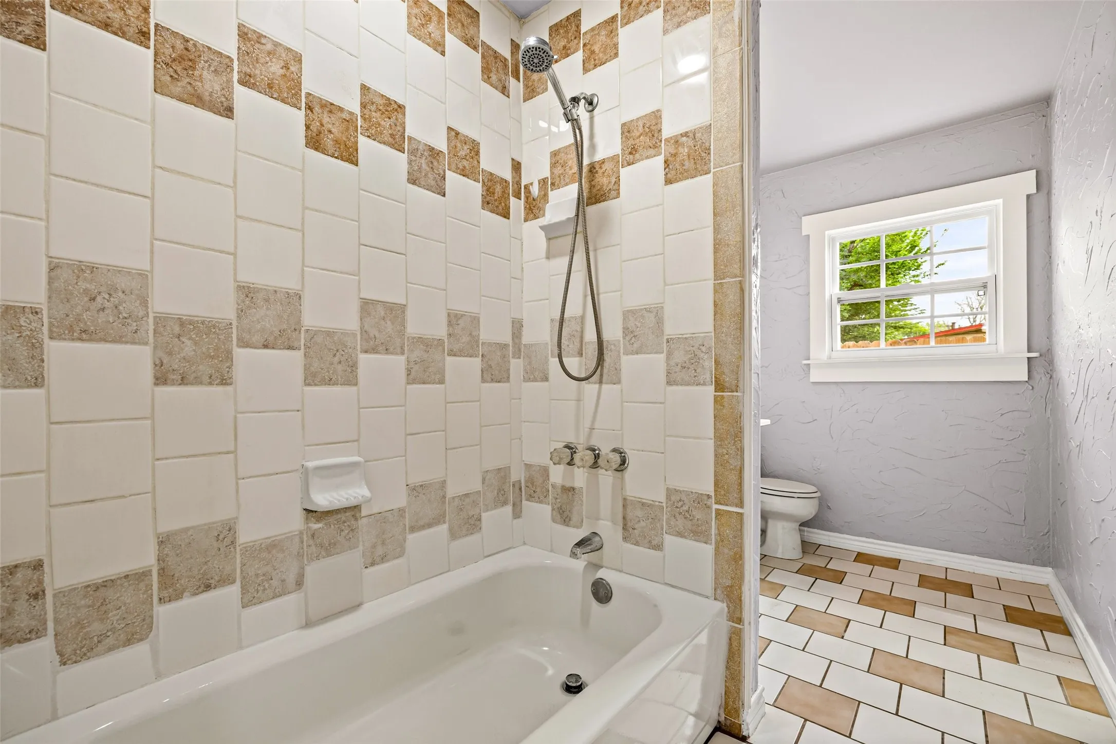 Full bath with bathtub / shower combination and tile patterned floors