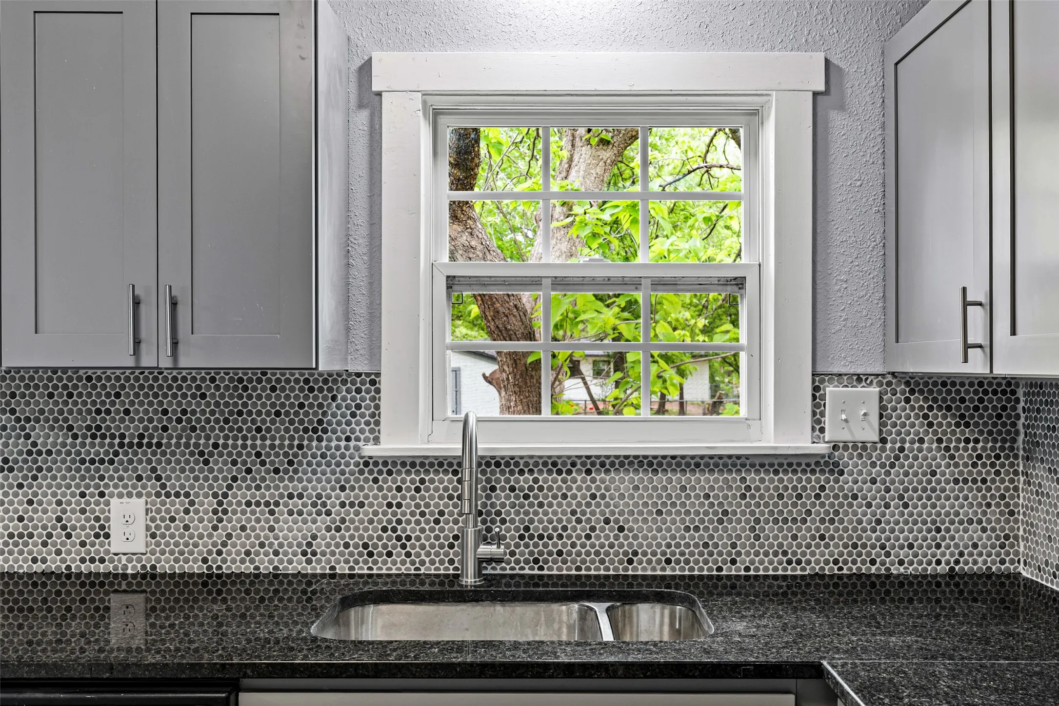 Kitchen featuring dark stone counters
