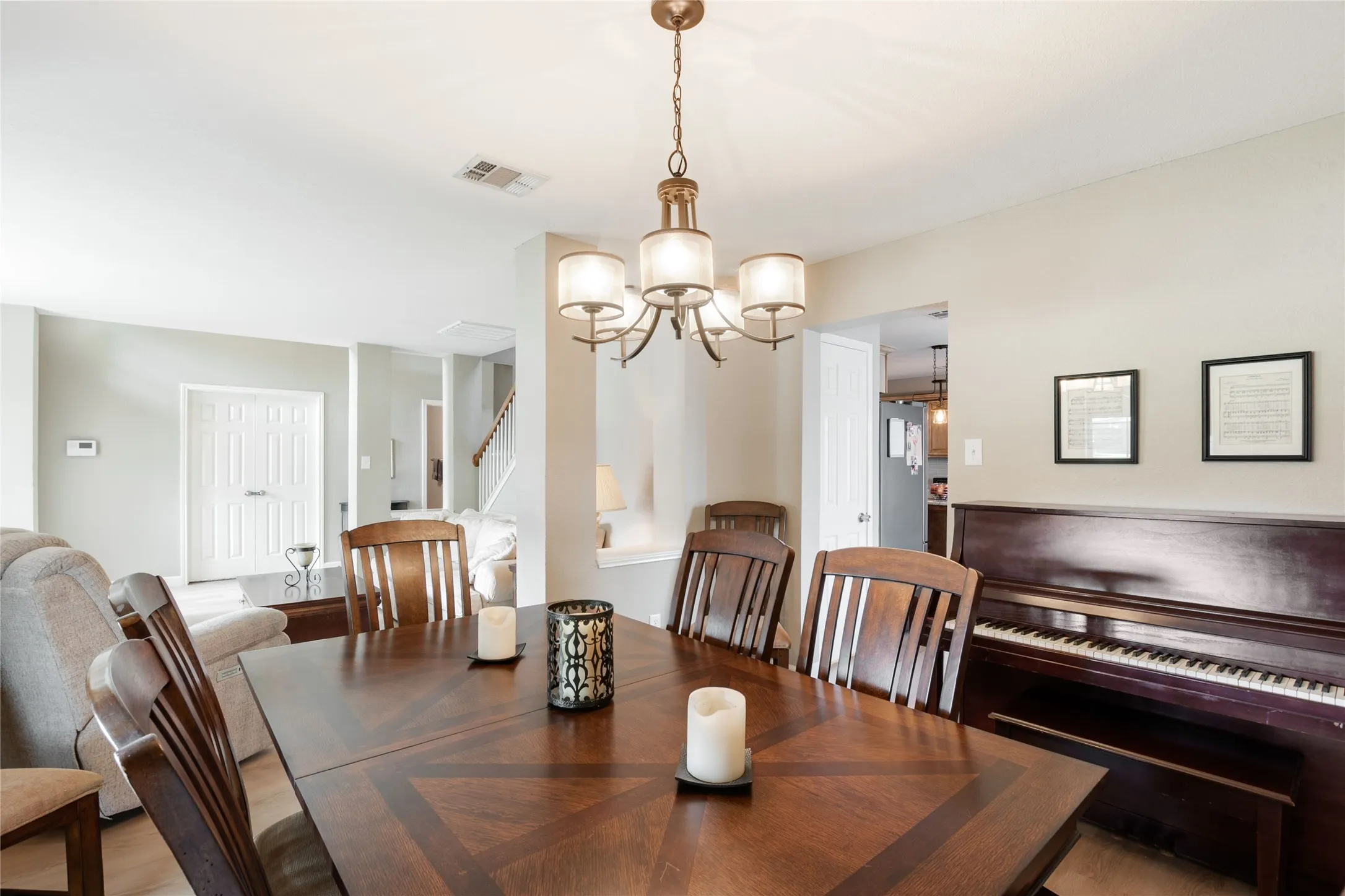 bright dining space with large window and elegant chandelier