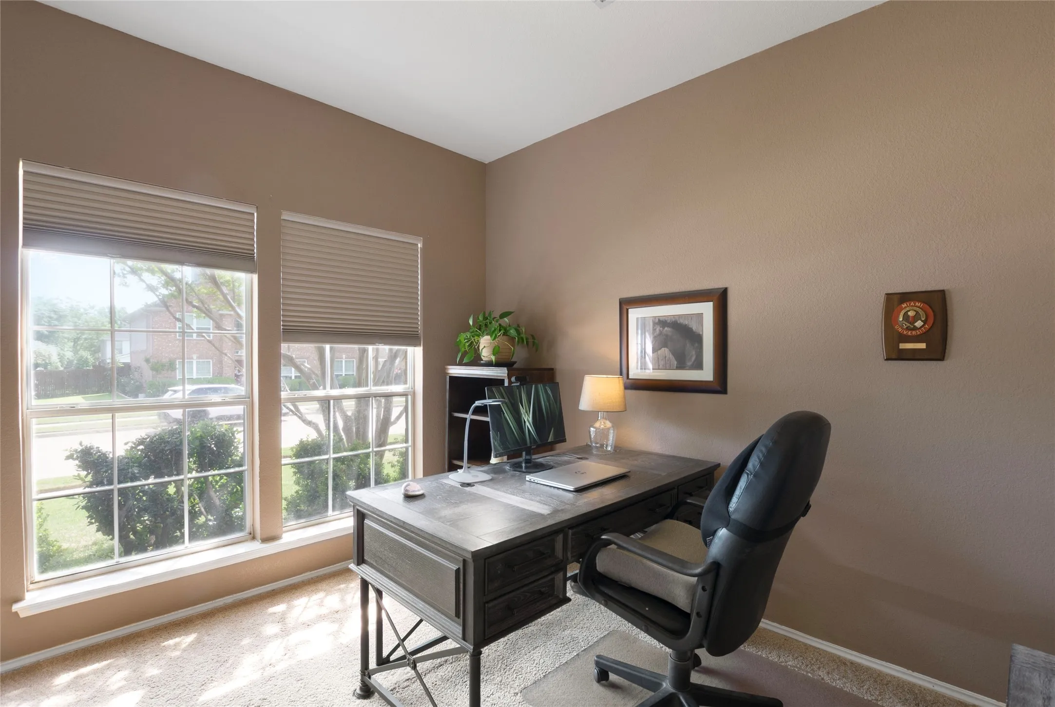 Office featuring light colored carpet and accent color walls