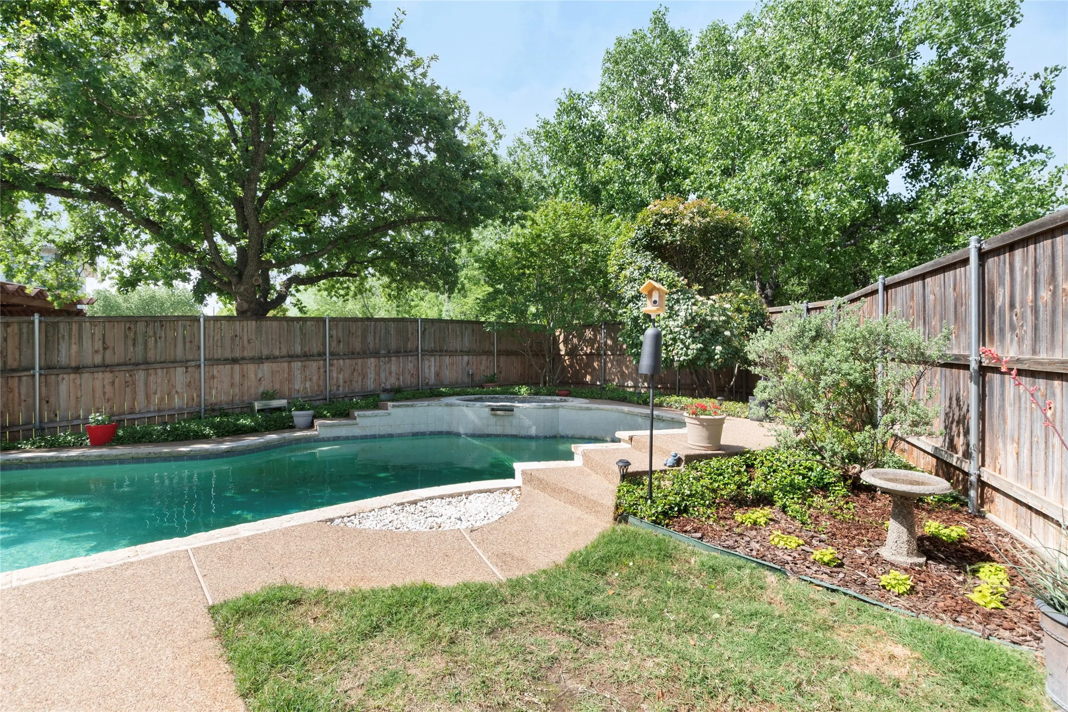 View of swimming pool featuring a fenced backyard and patio surround