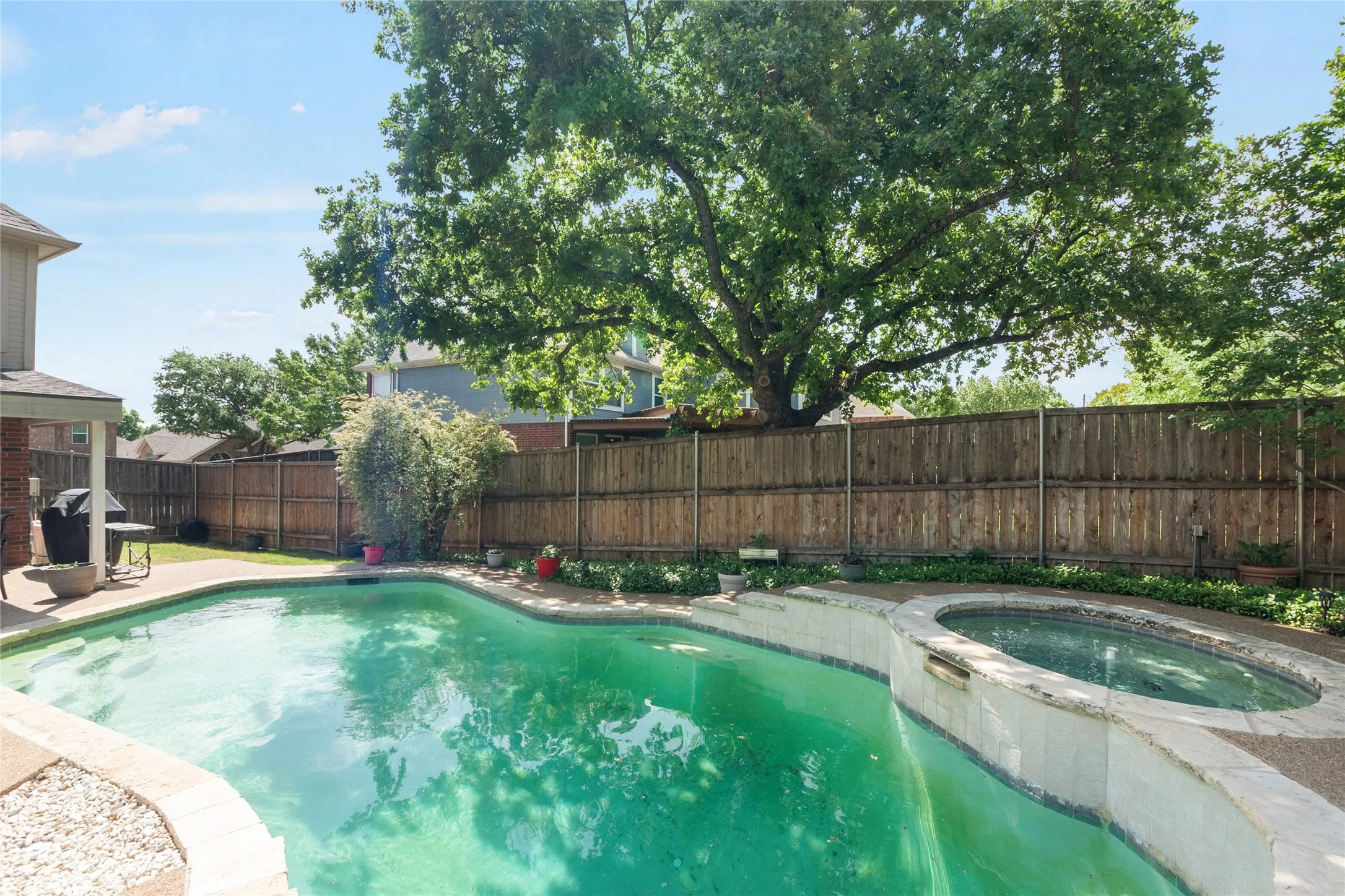 Relaxing pool / spa featuring a patio area and a fenced backyard