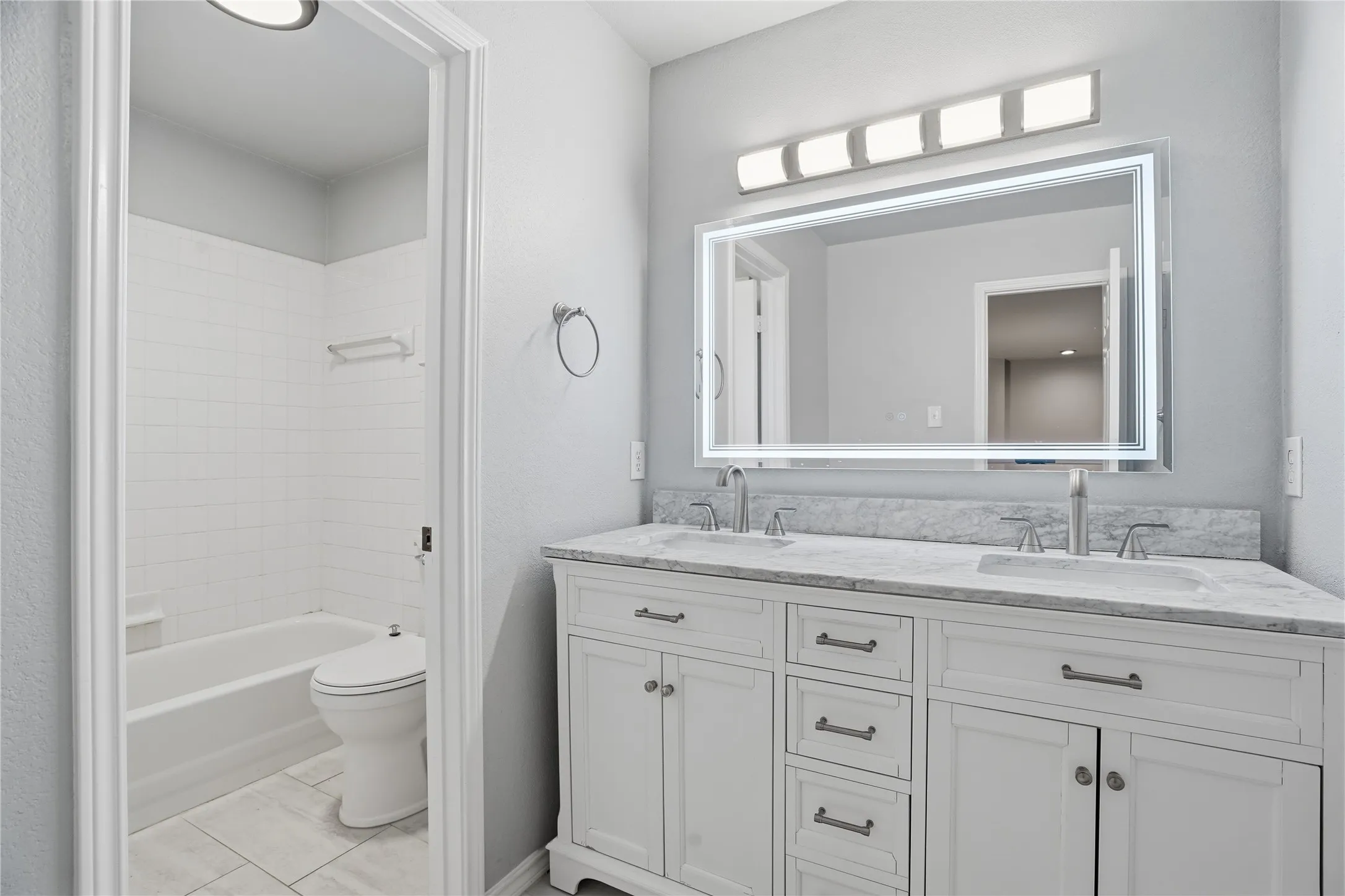 Updated Bathroom with double vanity and shower / tub combination