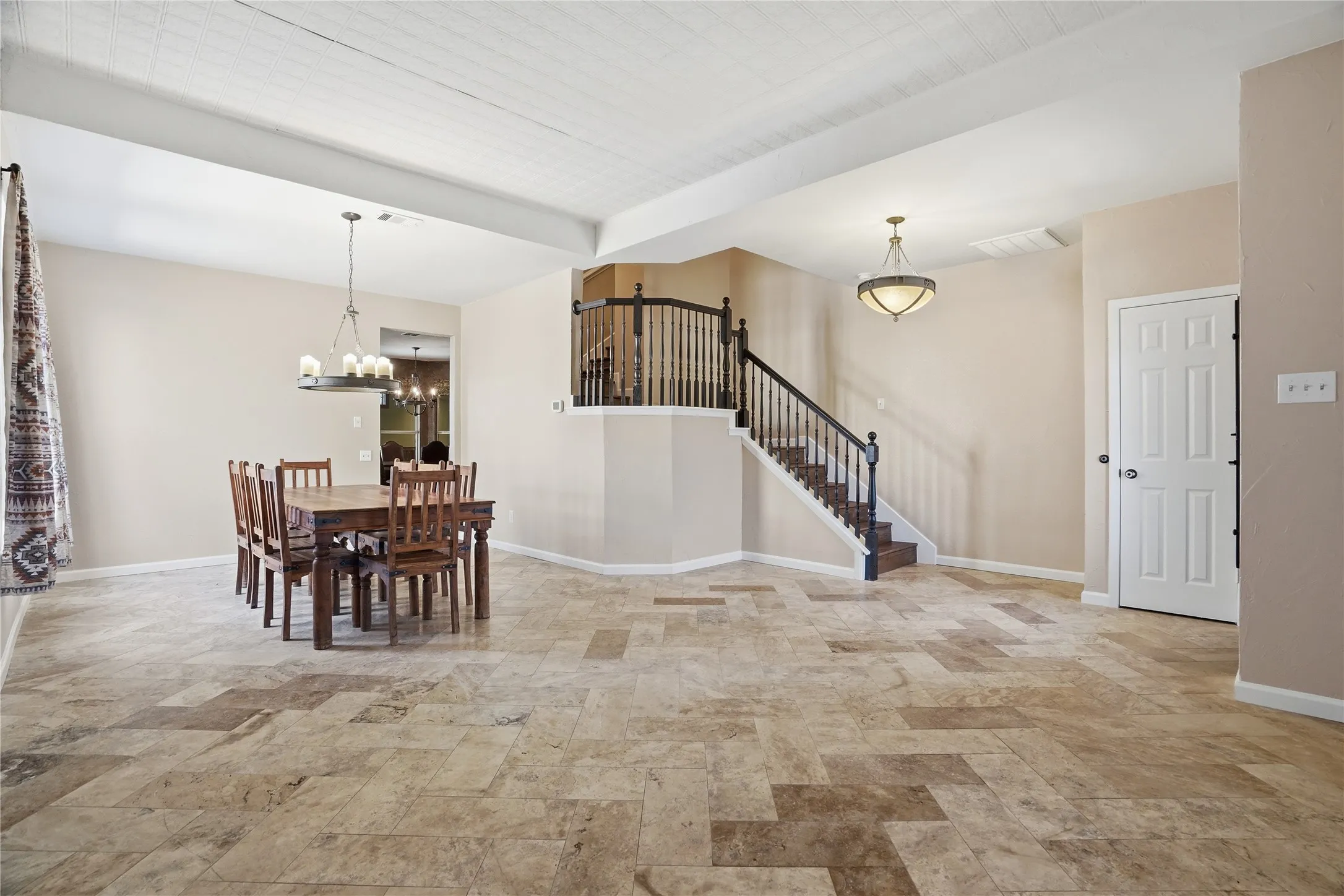 Dining room featuring stairs and a chandelier