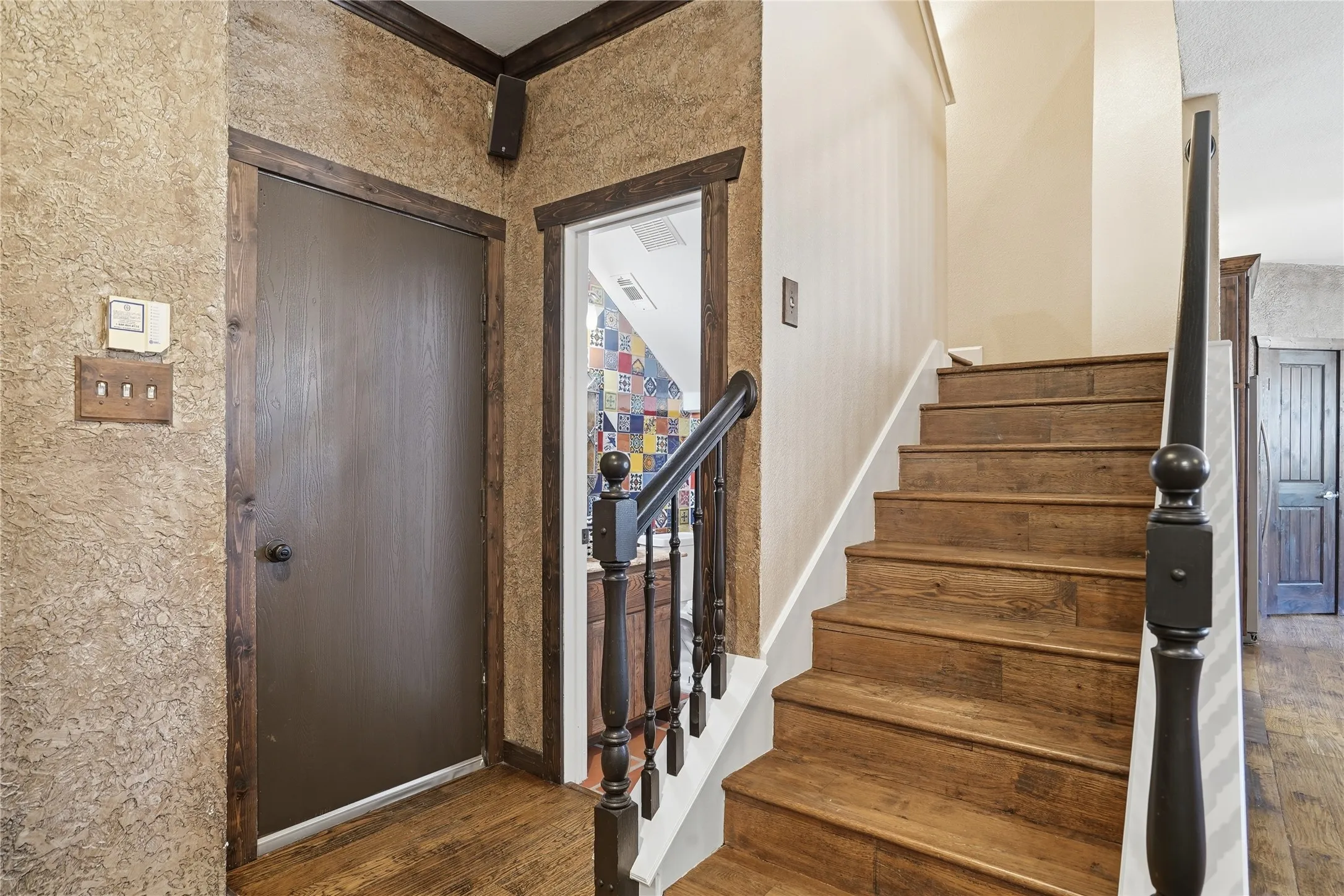 Garage Entryway with stairway and dark wood-style flooring