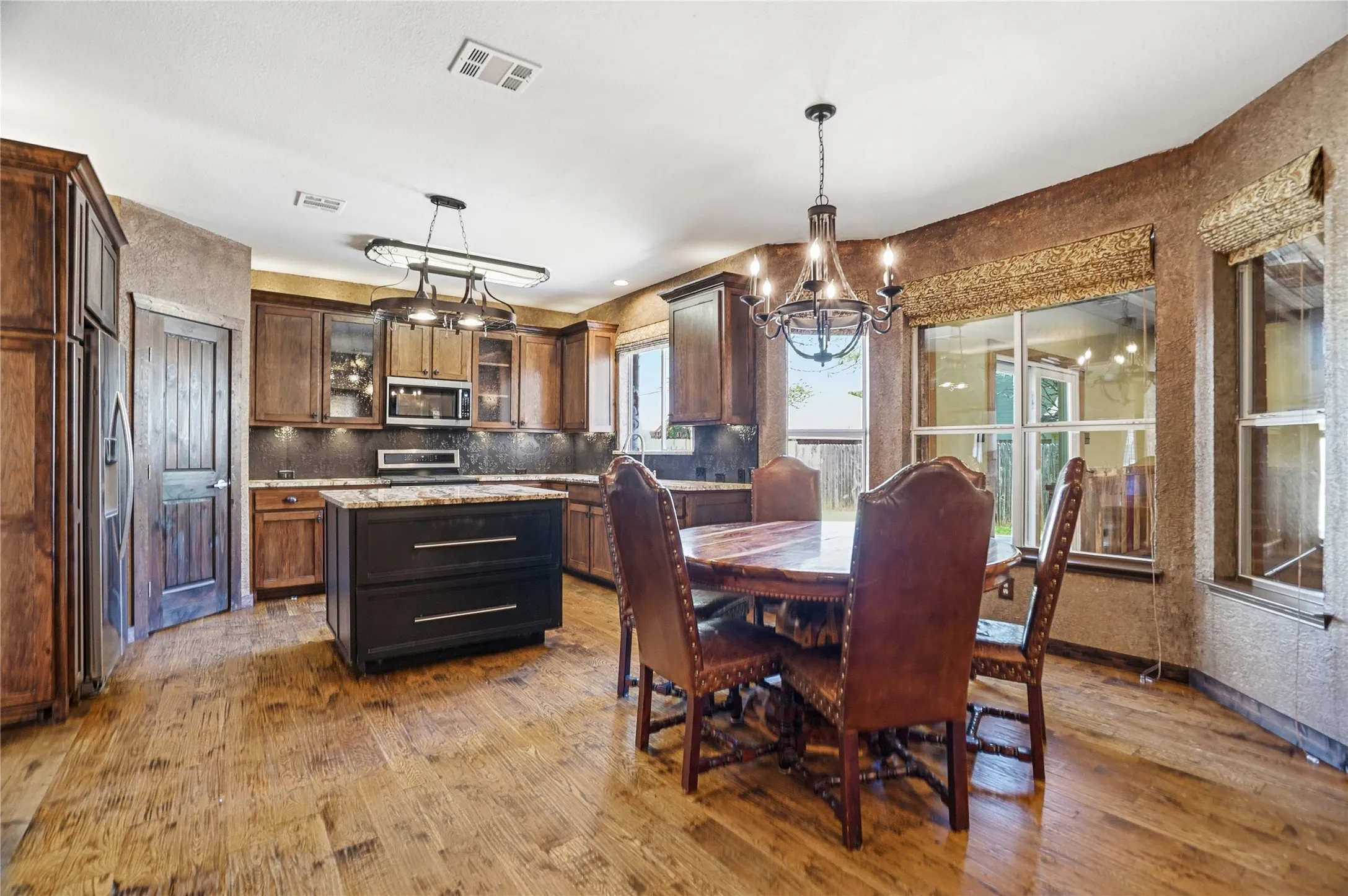 Dining space featuring a chandelier and dark wood finished floors
