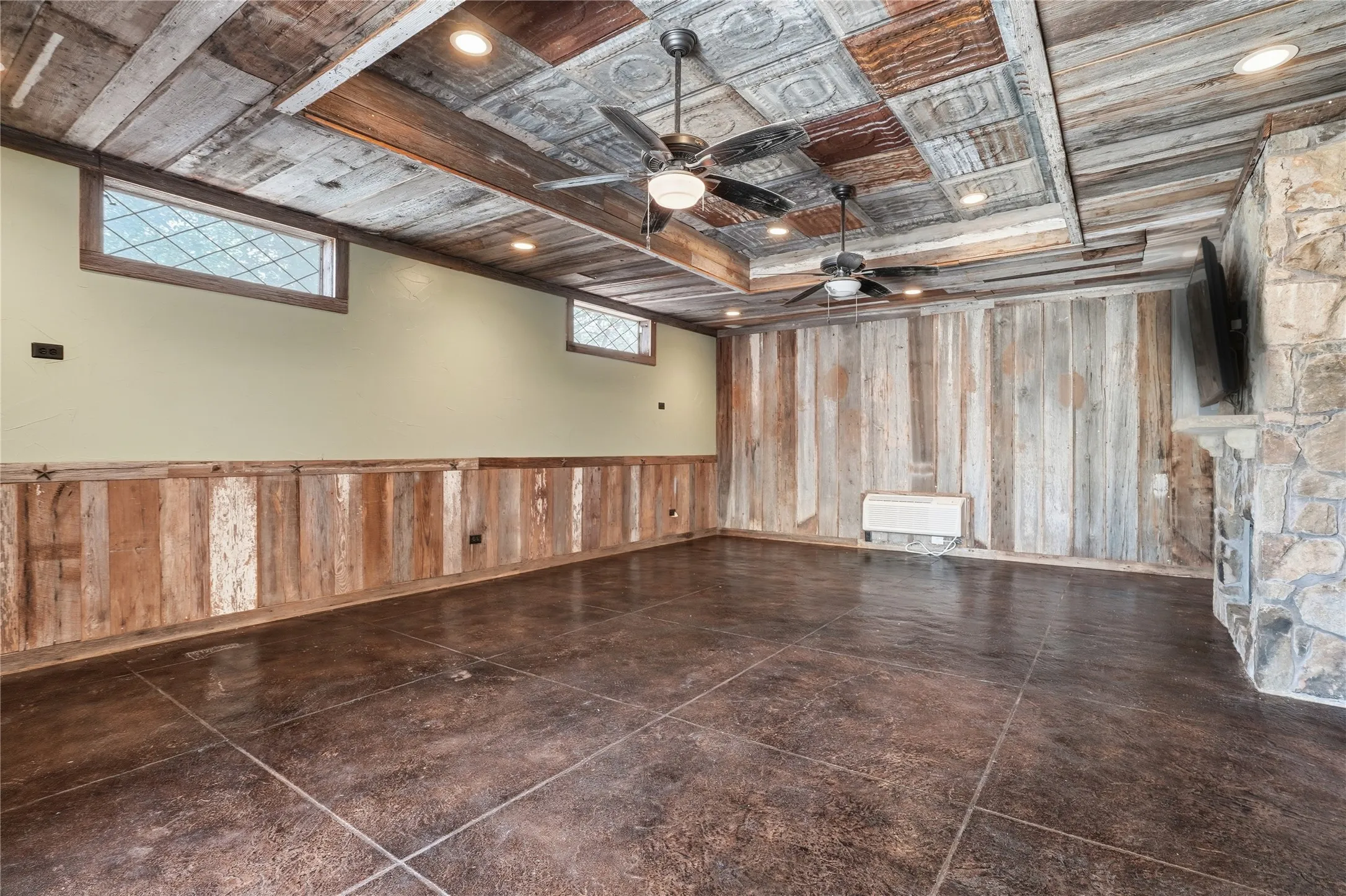 Spare room with wooden walls, recessed lighting, ceiling fan, and a raised ceiling