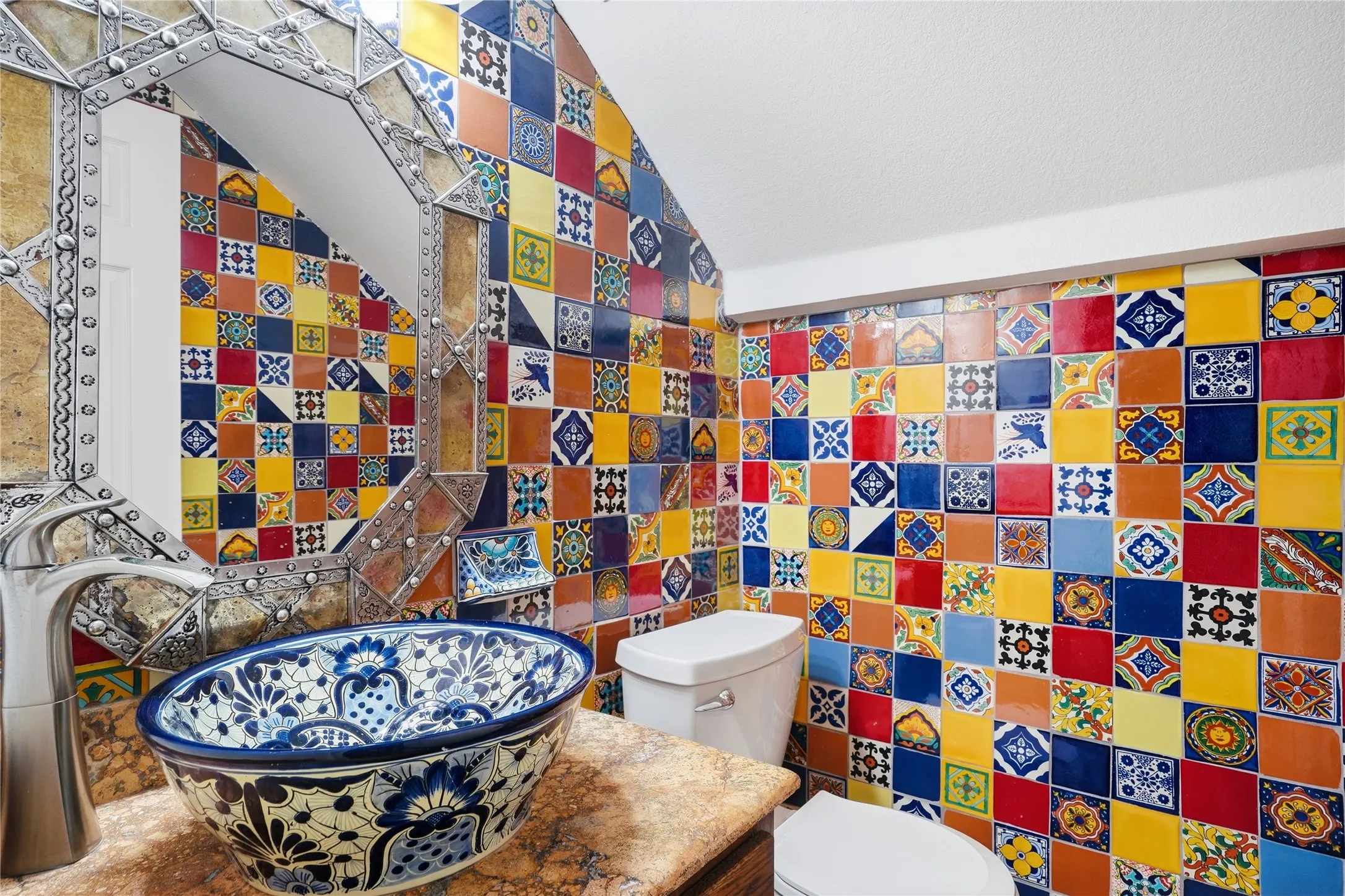 Half bath featuring tile walls, vanity, and vaulted ceiling