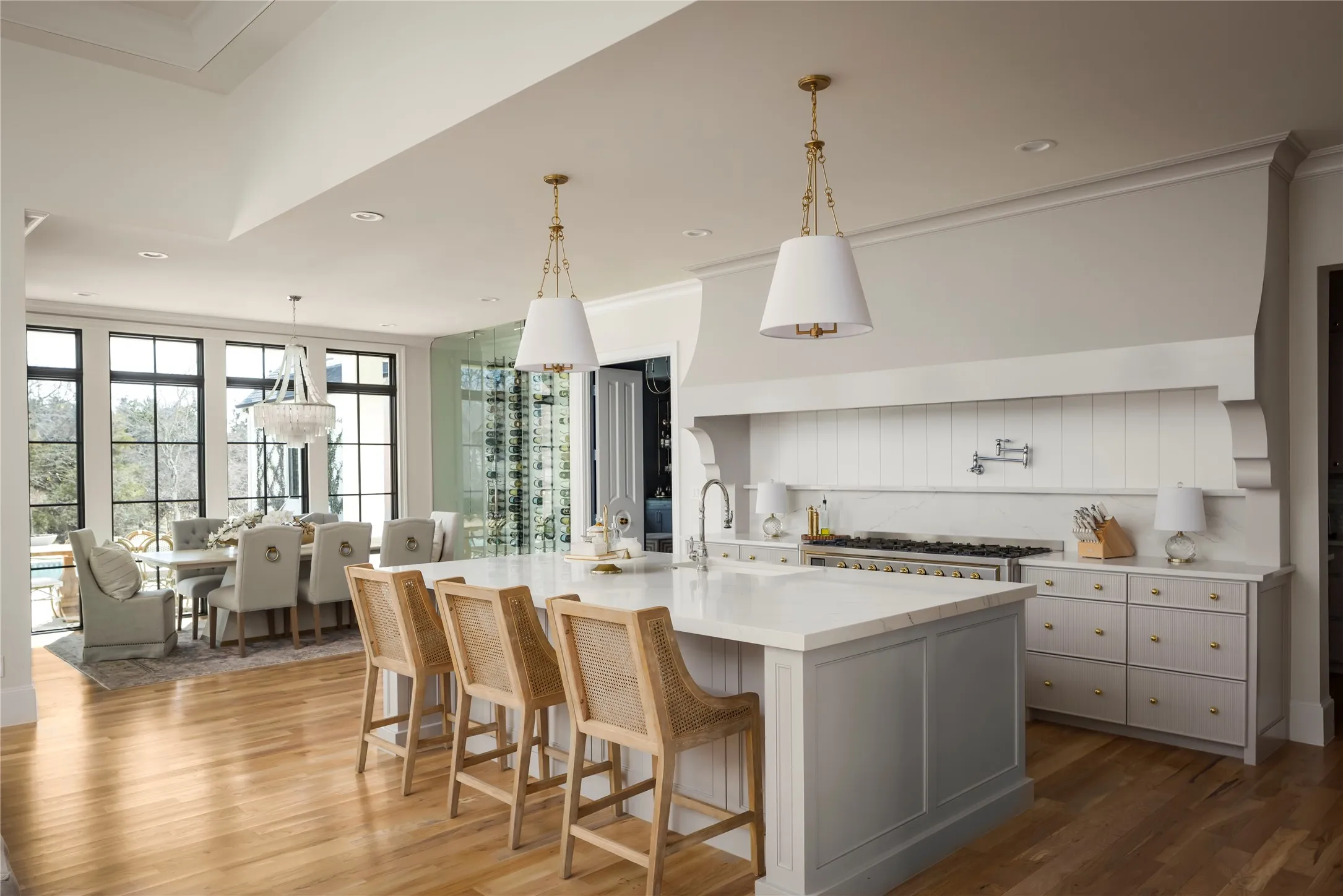 Large seamless island with beautiful quartz featuring a Waterstone Kitchen Faucet and plenty of storge on both sides of the island