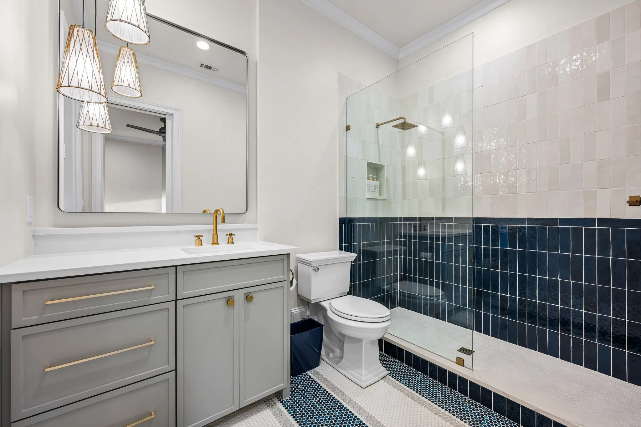 The detailing in the tile work in the shower and on the floor is just as sophisticated as the accent wall in the bedroom! This ensuite bath also offers the walk in closet