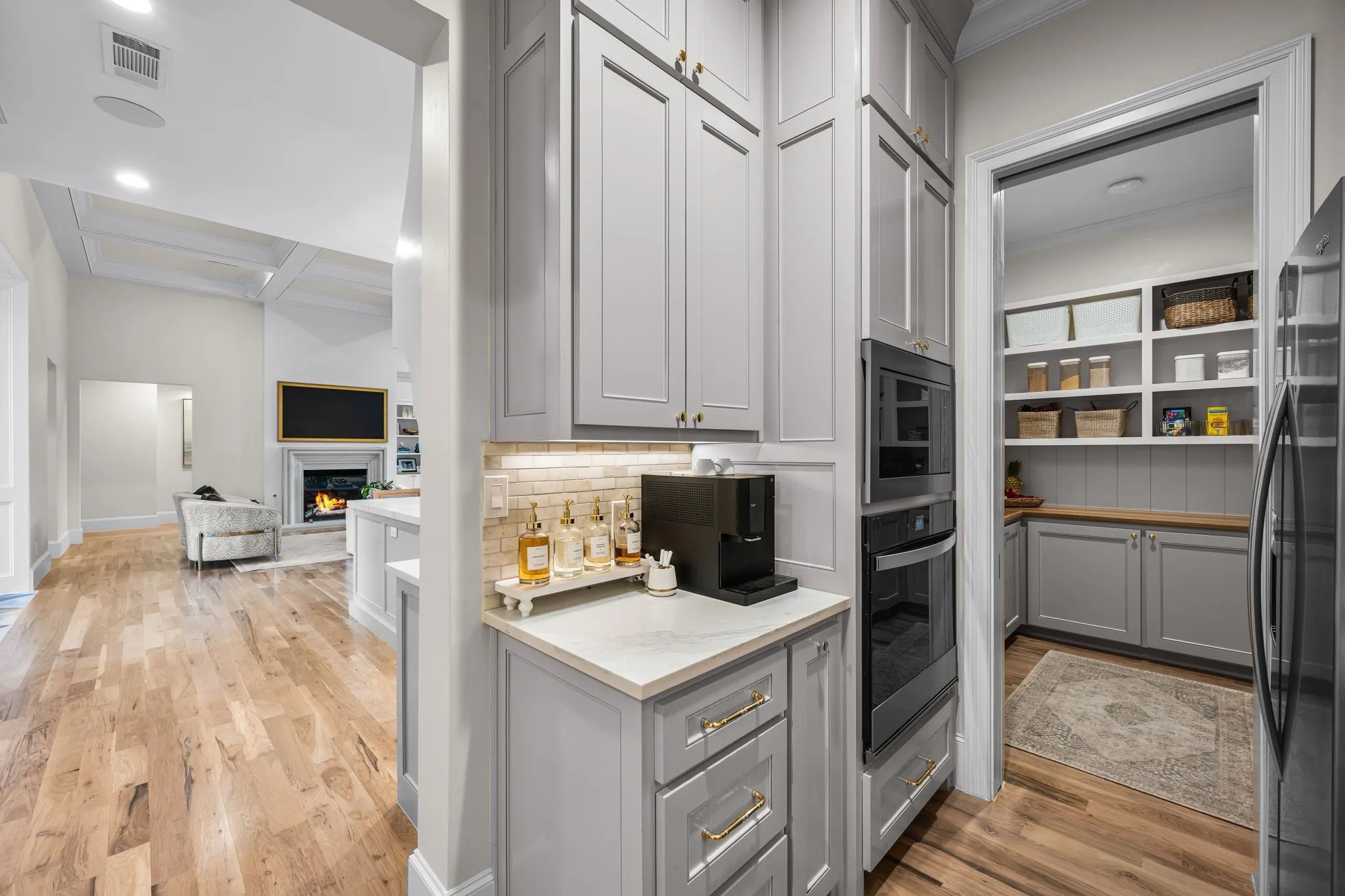 Prep kitchen features oven, microwave, refrigerator and dishwasher. Cabinets are SW Colonnade grey