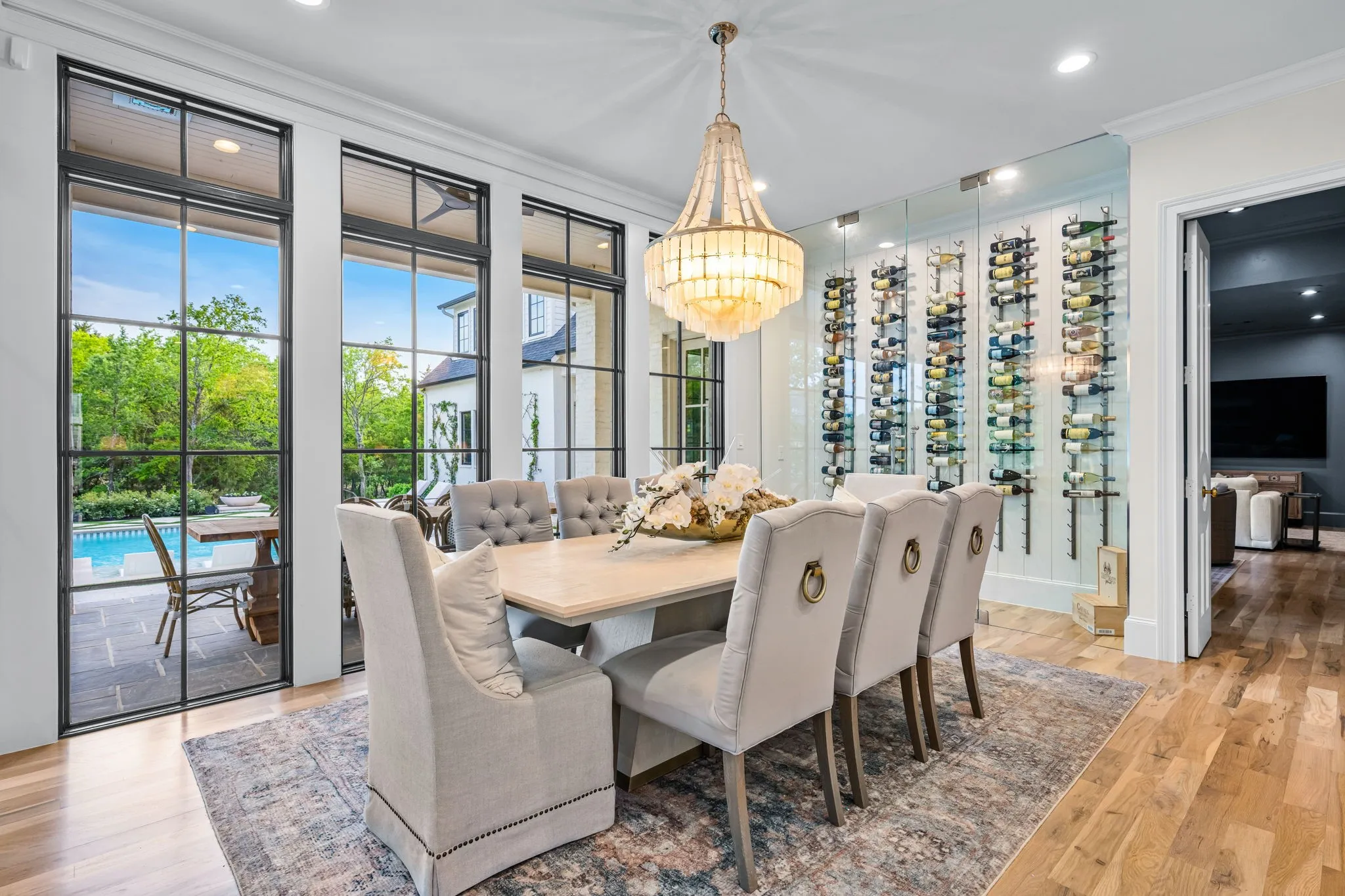 Large dining overlooking the backyard oasis along with your own personal built in glass front wine cabinet