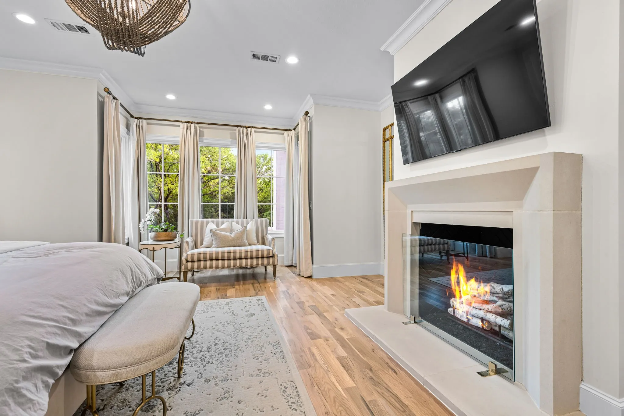 Gas started fireplace featured in the primary retreat, along with a sitting area overlooking the backyard